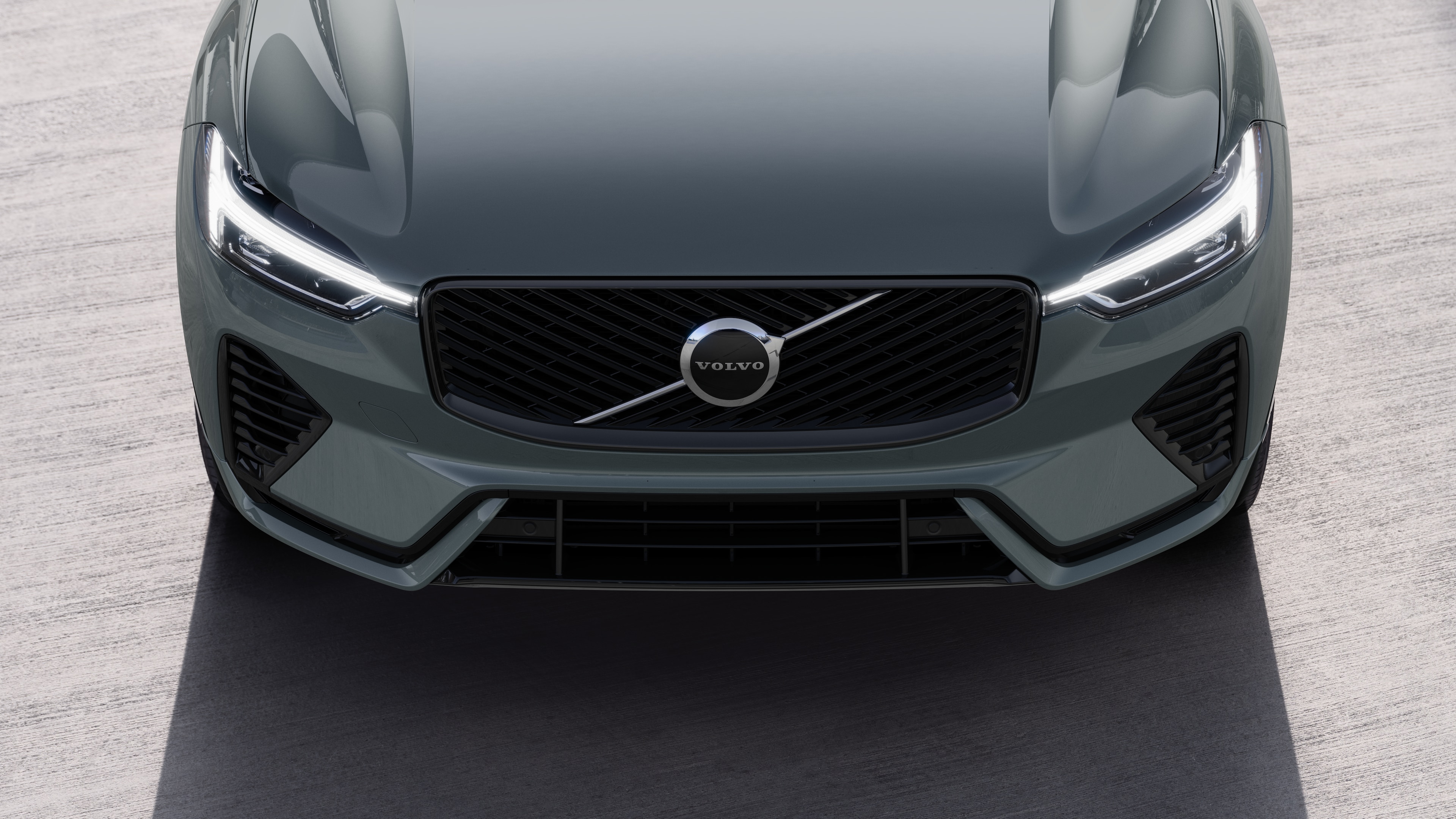 Volvo car exterior in three-quarter view on an urban street background, showing one side, roof, and part of the front.