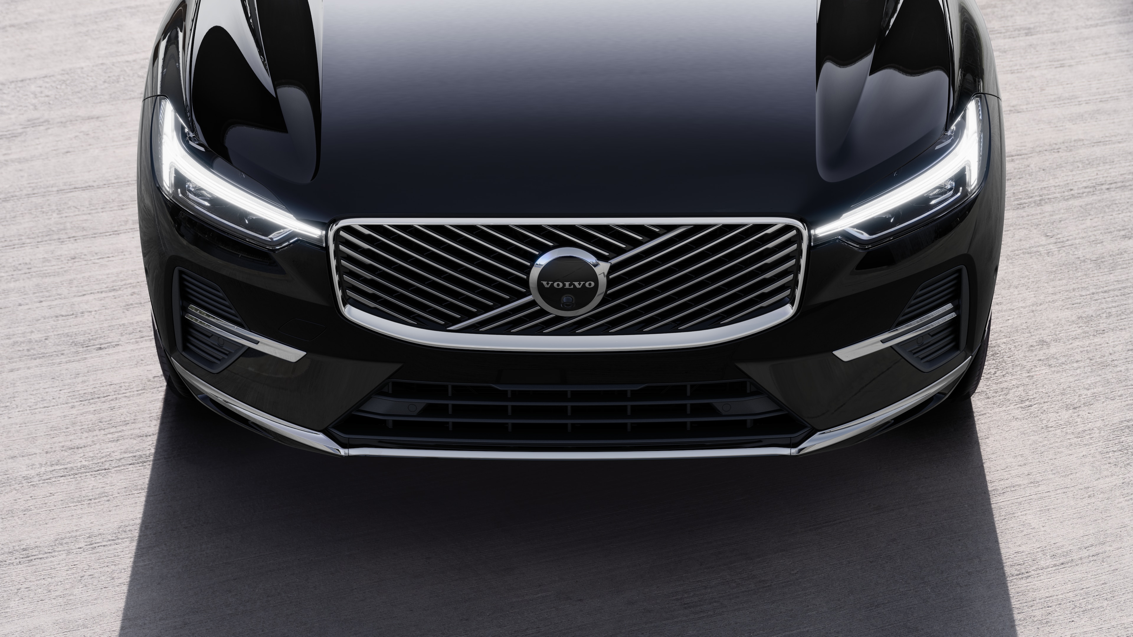 Volvo car exterior in three-quarter view on an urban street background, showing one side, roof, and part of the front.