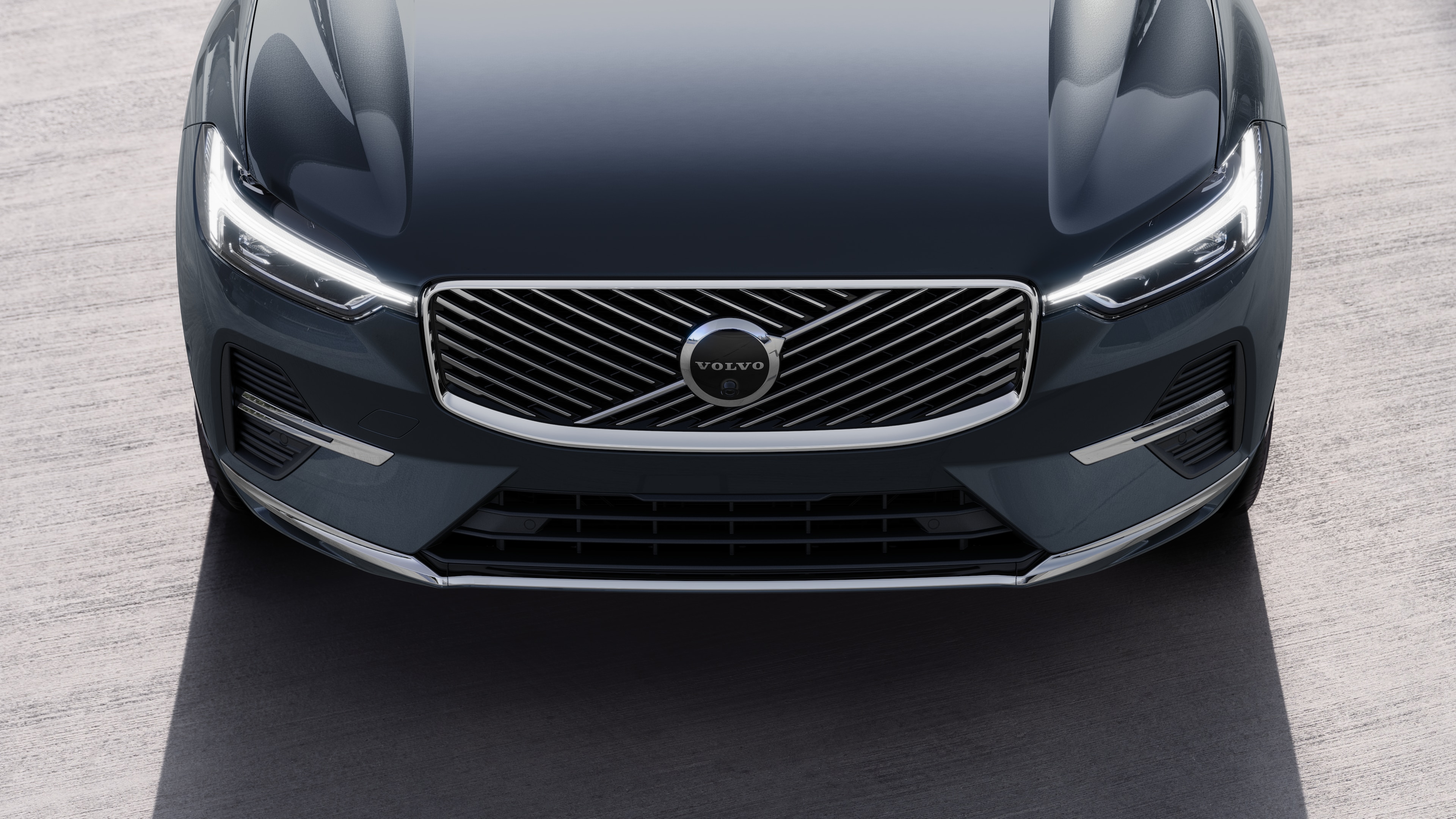 Volvo car exterior in three-quarter view on an urban street background, showing one side, roof, and part of the front.