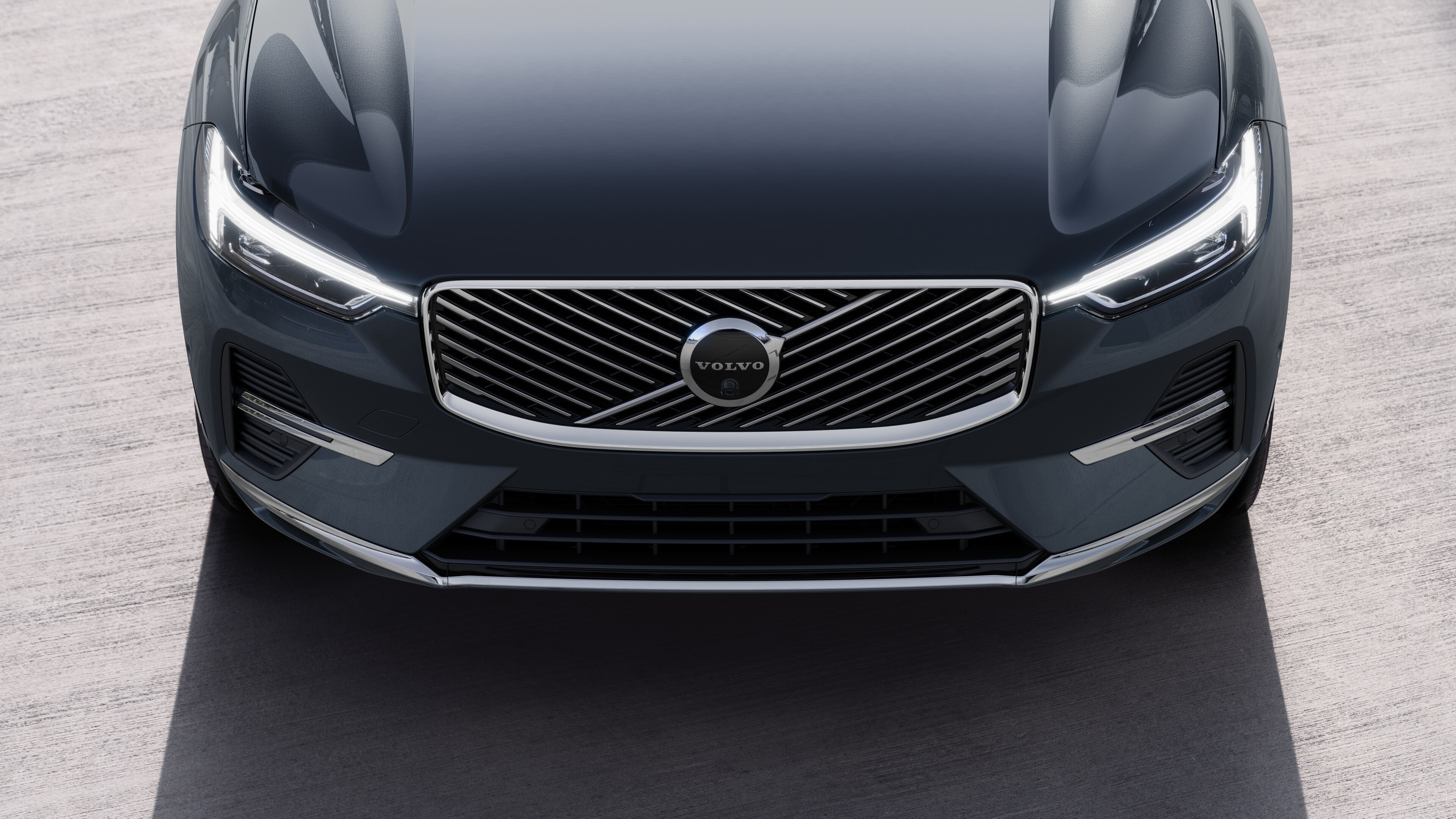 Volvo car exterior in three-quarter view on an urban street background, showing one side, roof, and part of the front.