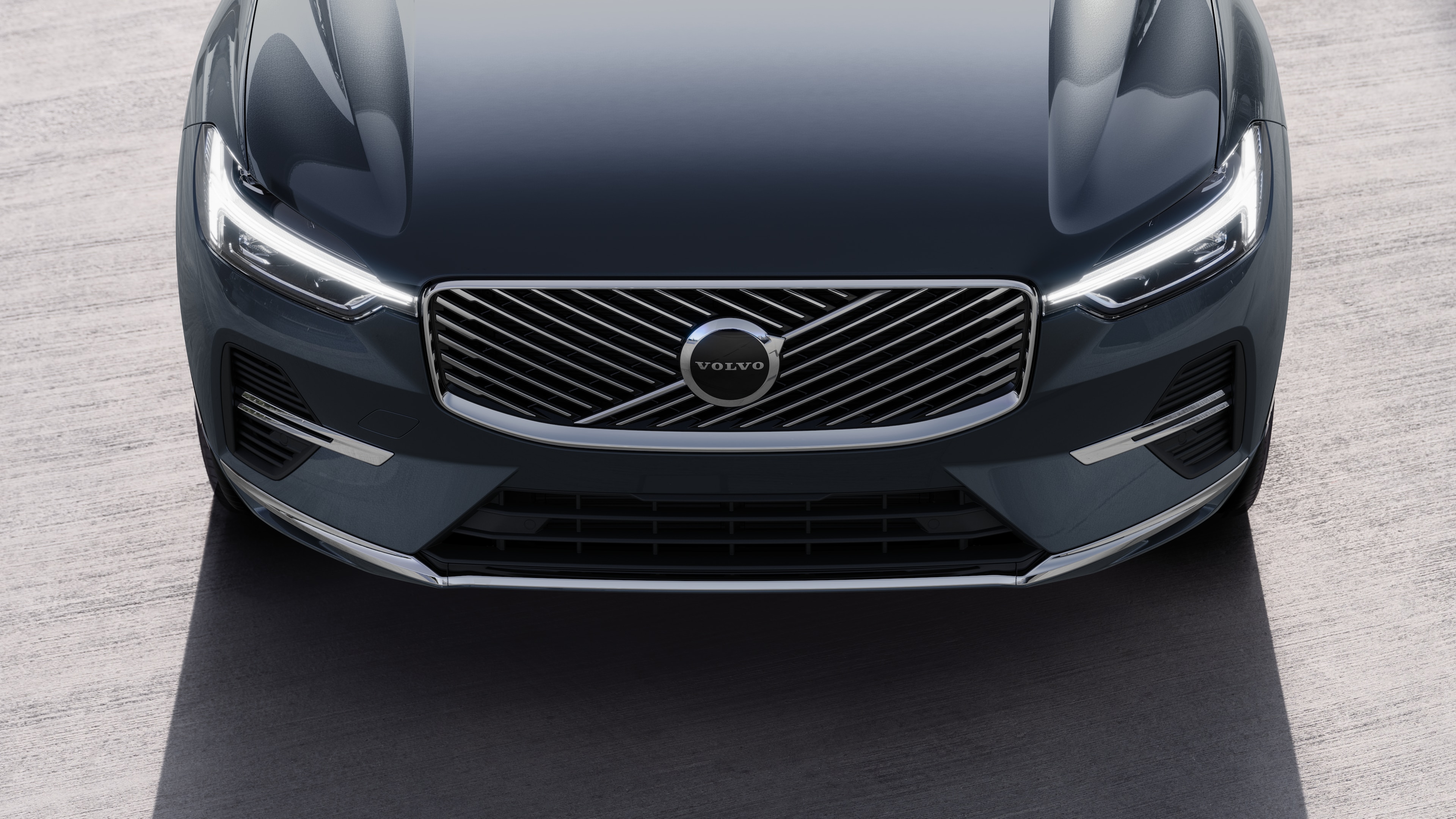 Volvo car exterior in three-quarter view on an urban street background, showing one side, roof, and part of the front.