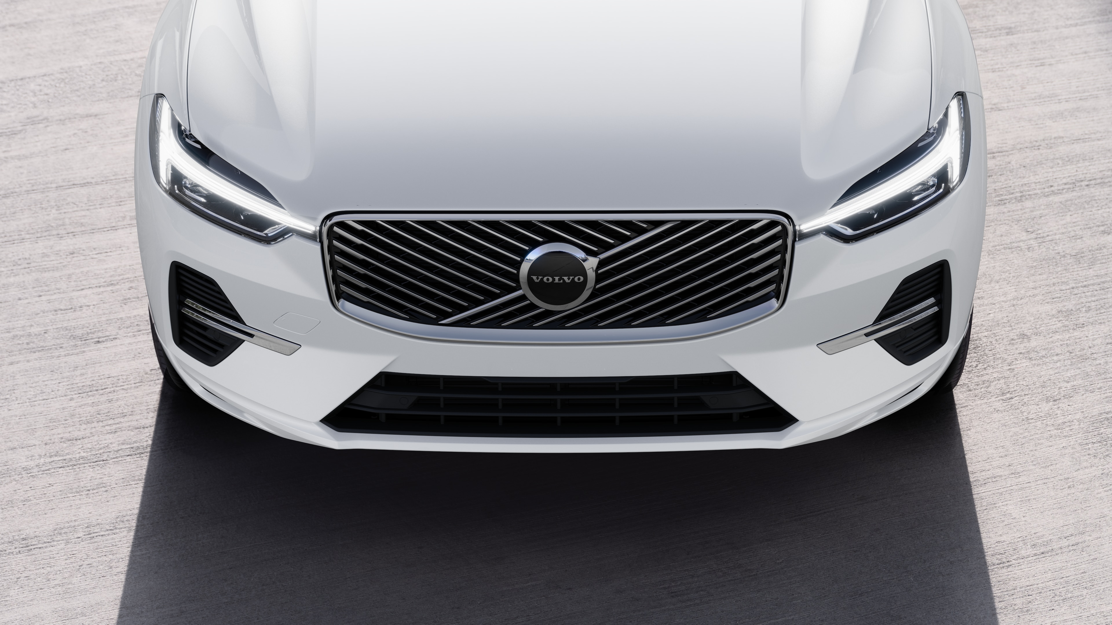 Volvo car exterior in three-quarter view on an urban street background, showing one side, roof, and part of the front.