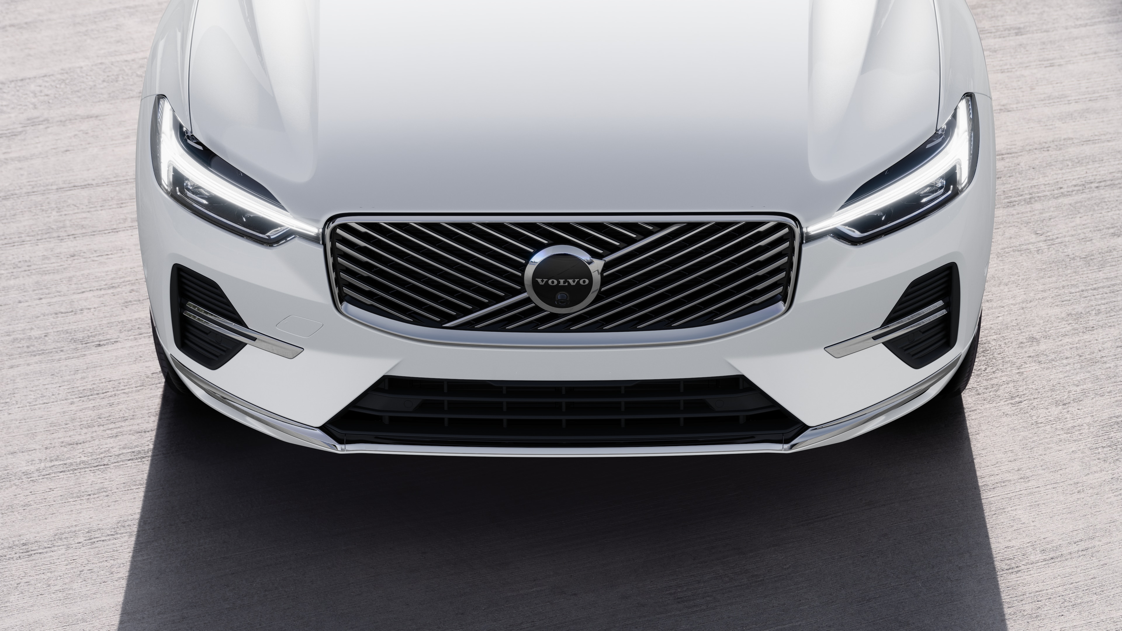 Volvo car exterior in three-quarter view on an urban street background, showing one side, roof, and part of the front.