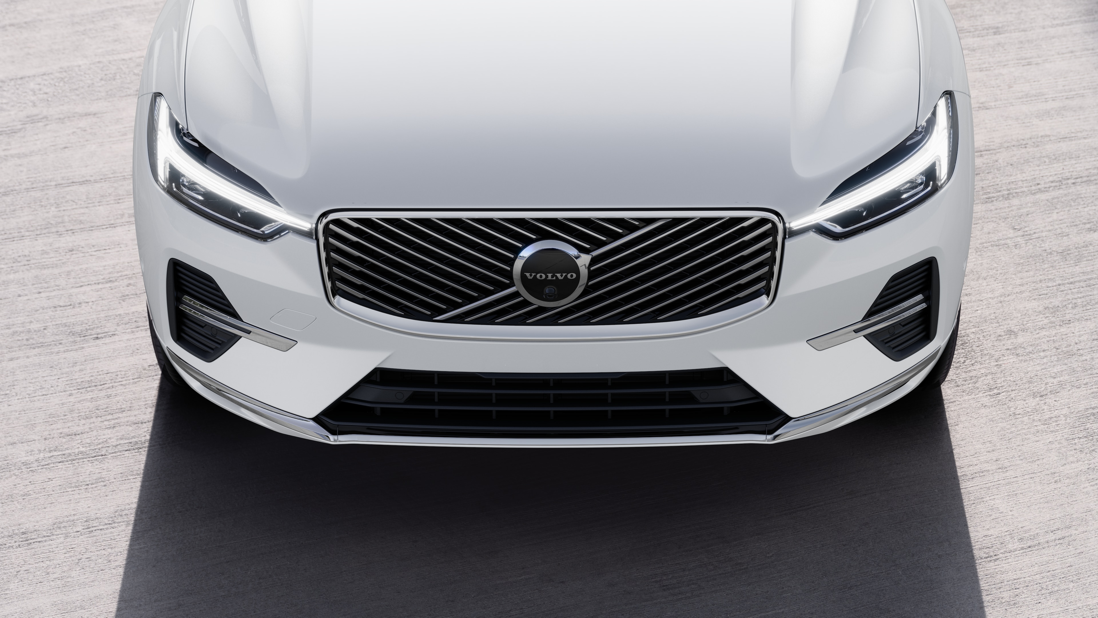 Volvo car exterior in three-quarter view on an urban street background, showing one side, roof, and part of the front.