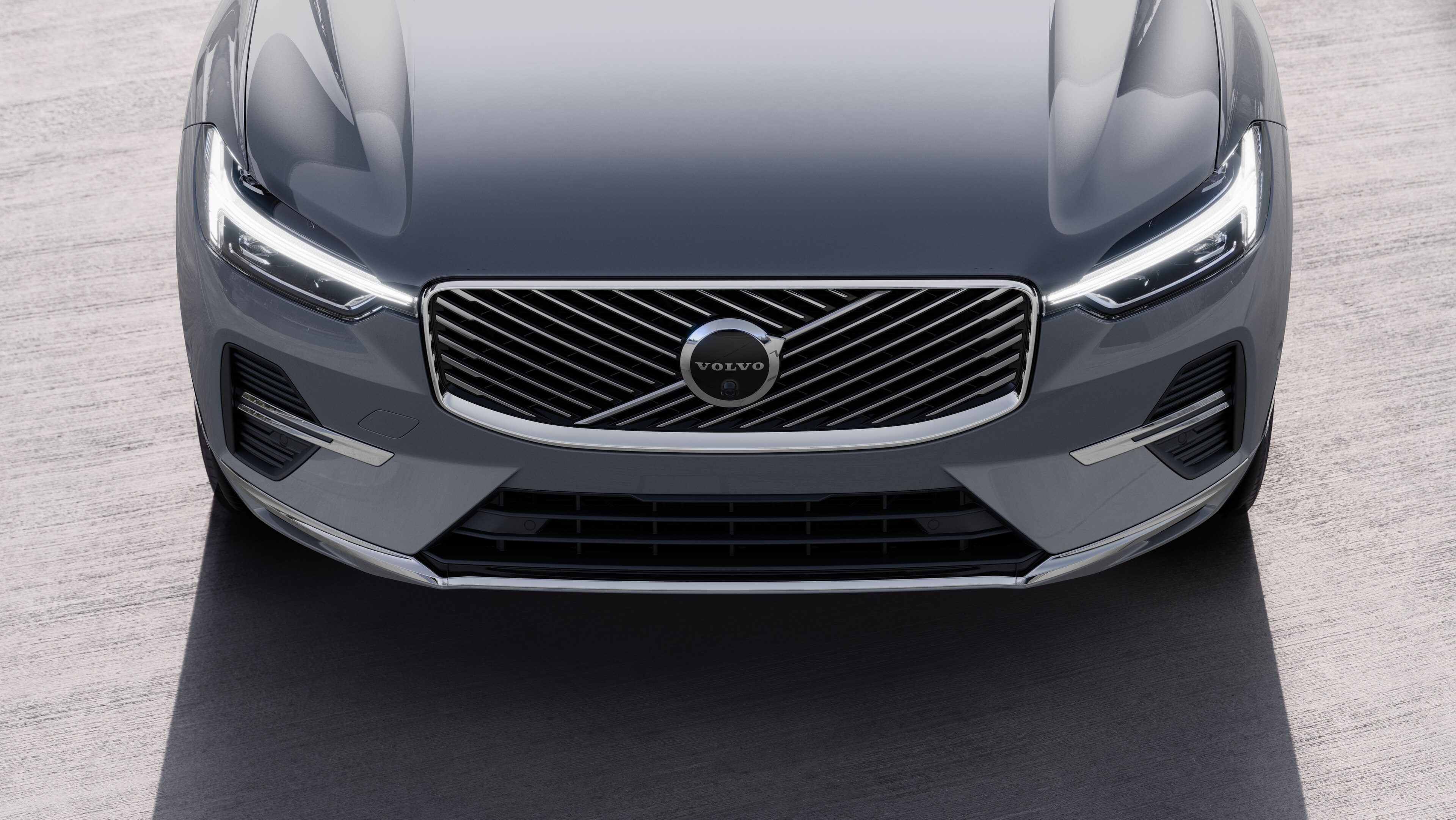 Volvo car exterior in three-quarter view on an urban street background, showing one side, roof, and part of the front.