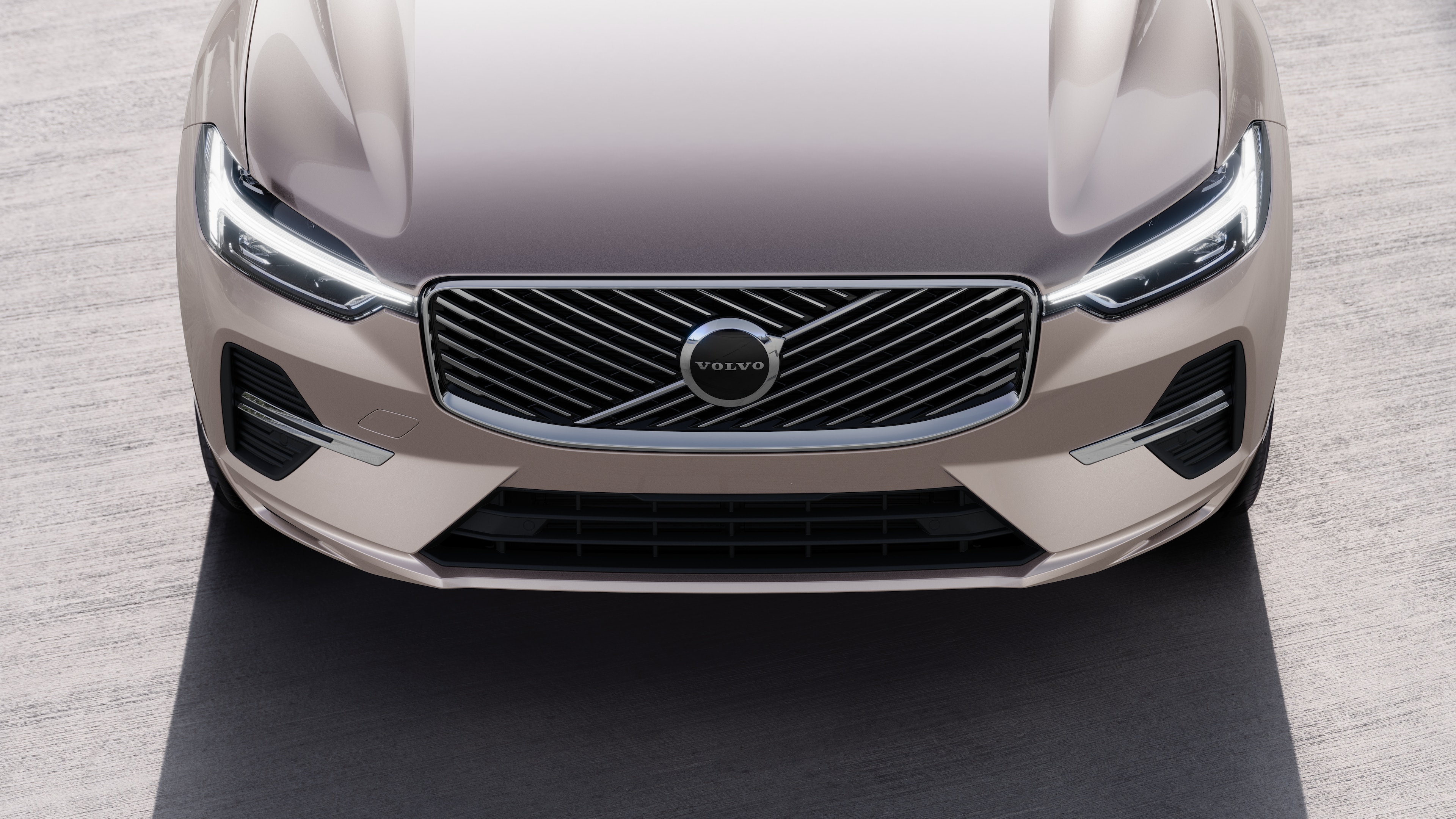 Volvo car exterior in three-quarter view on an urban street background, showing one side, roof, and part of the front.