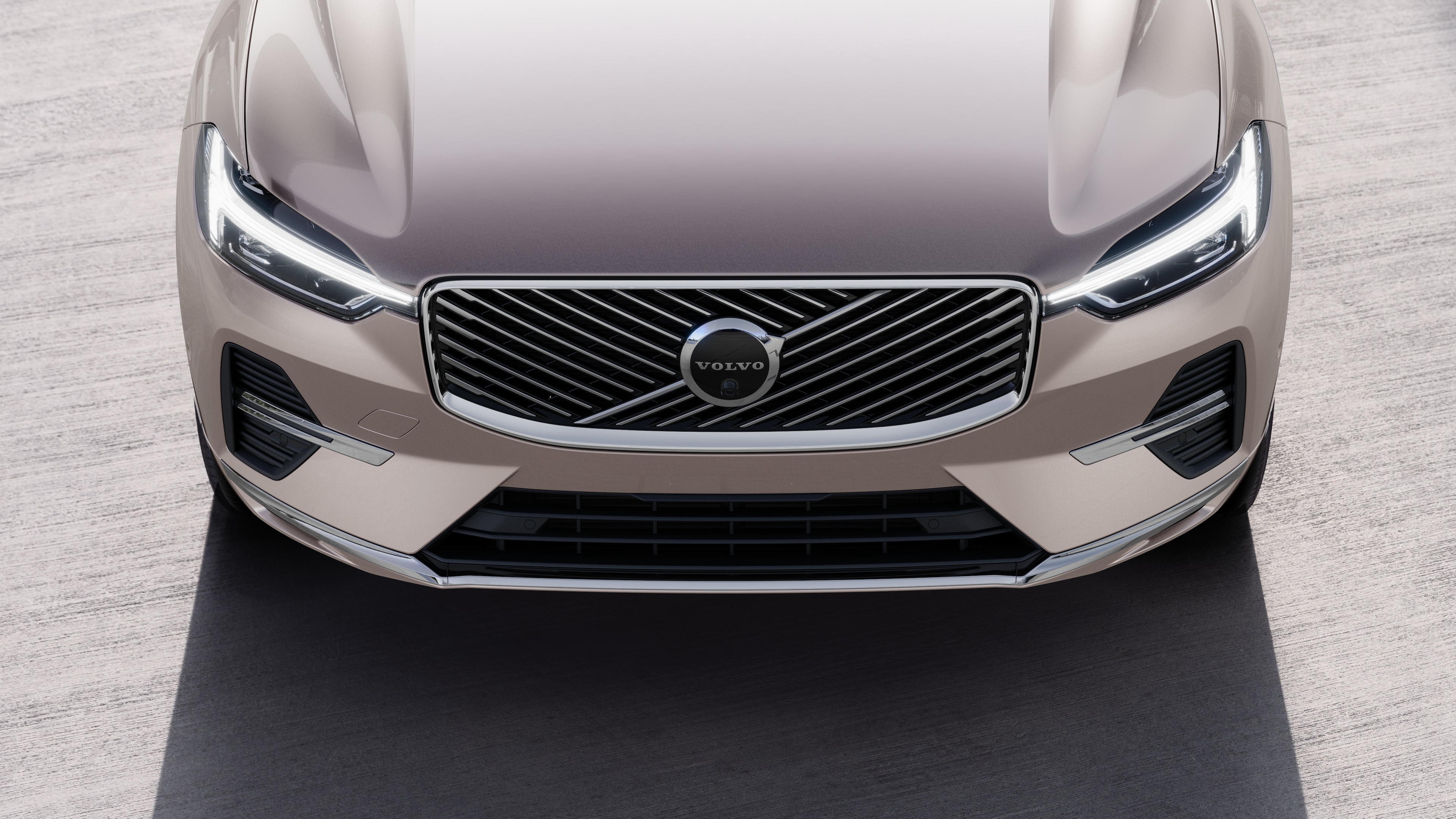 Volvo car exterior in three-quarter view on an urban street background, showing one side, roof, and part of the front.