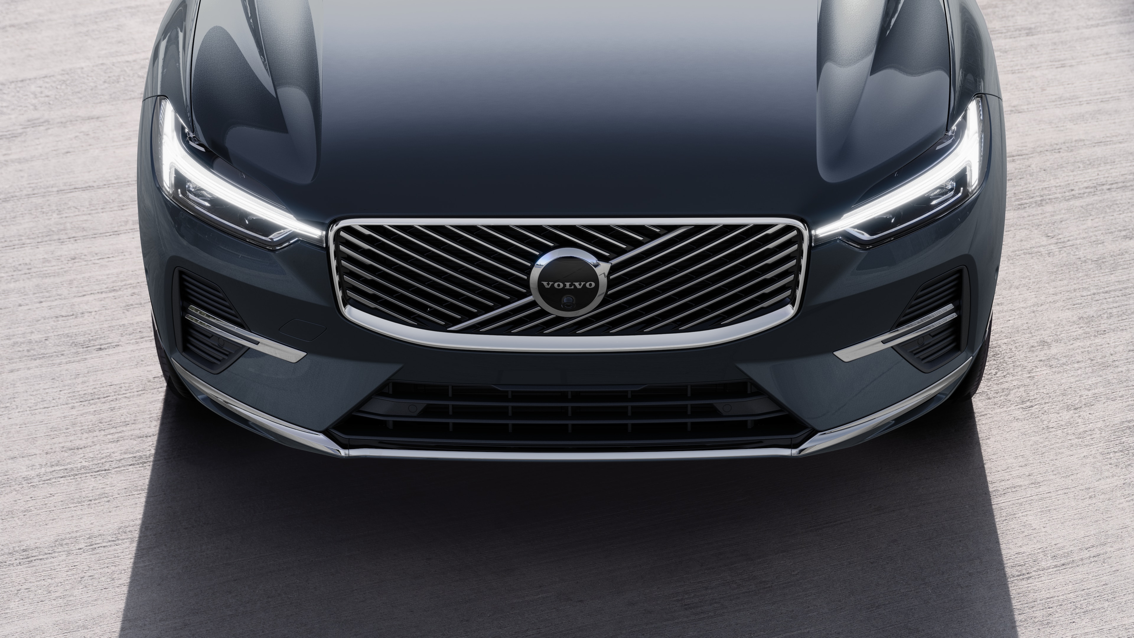 Volvo car exterior in three-quarter view on an urban street background, showing one side, roof, and part of the front.