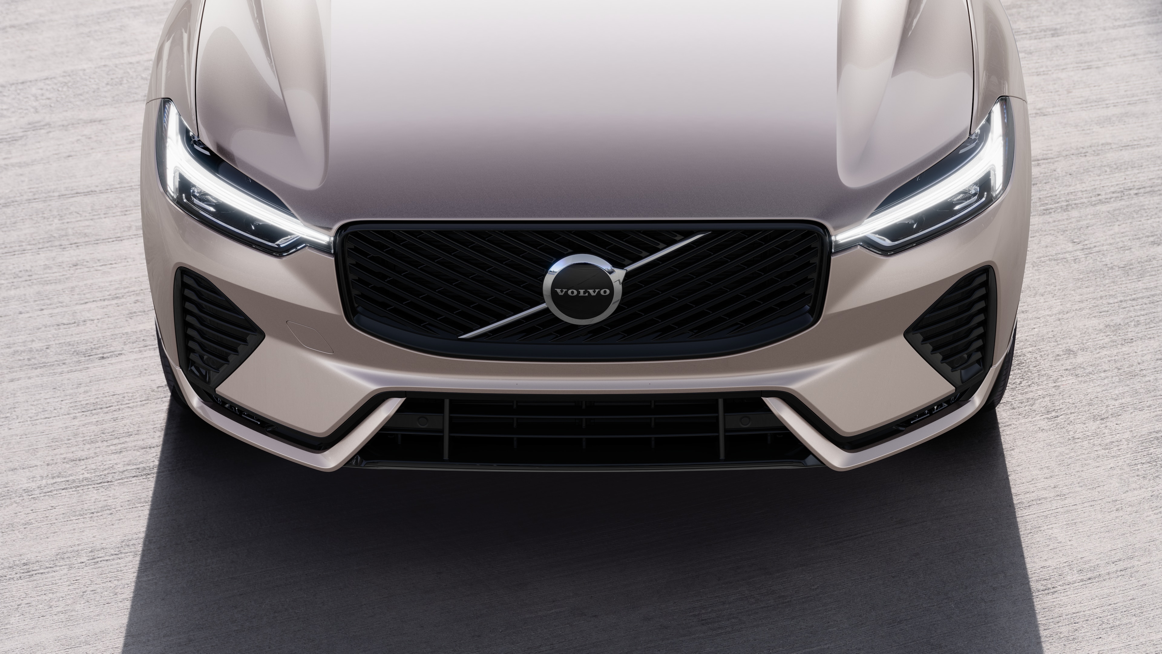 Volvo car exterior in three-quarter view on an urban street background, showing one side, roof, and part of the front.