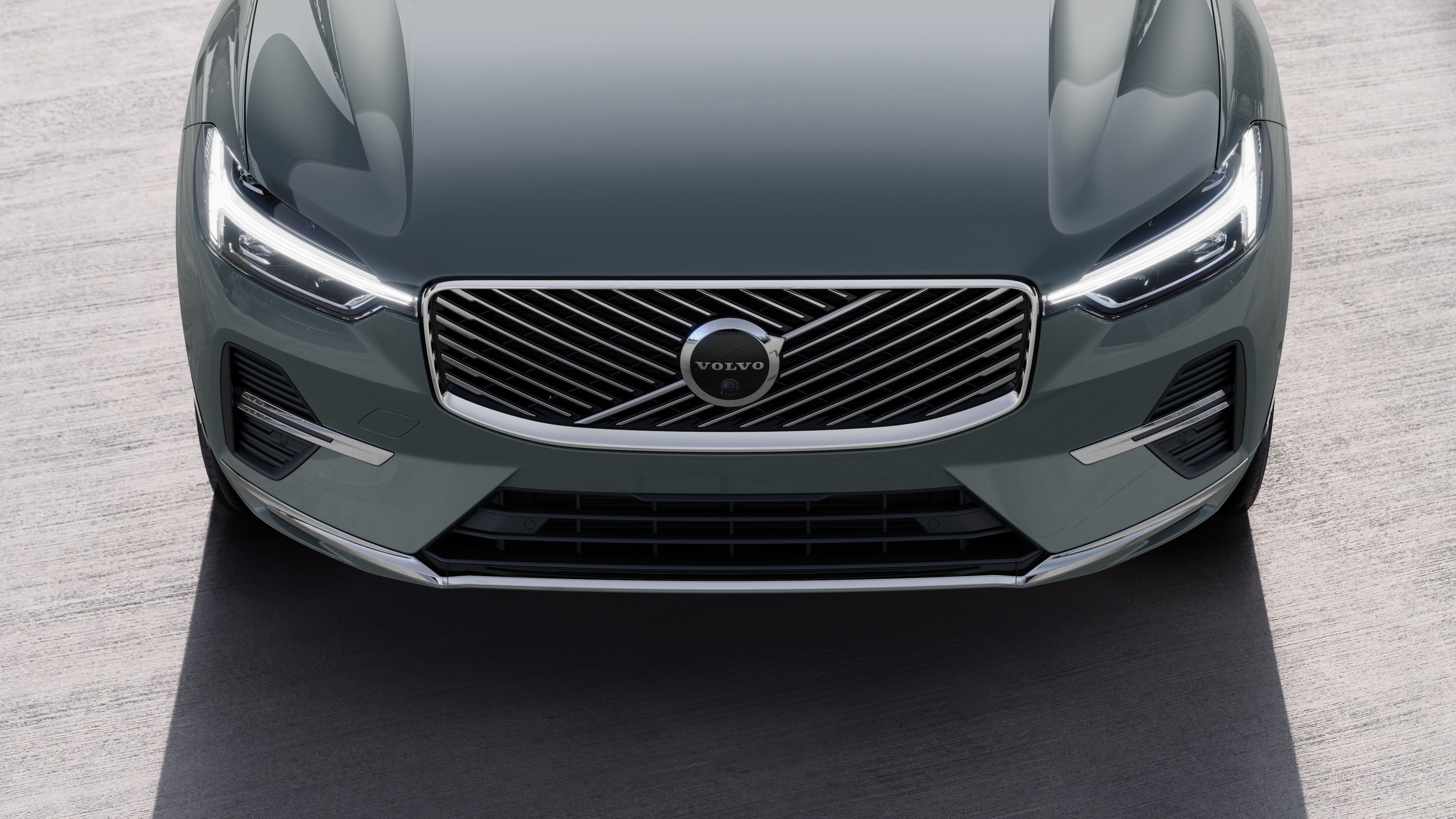 Volvo car exterior in three-quarter view on an urban street background, showing one side, roof, and part of the front.