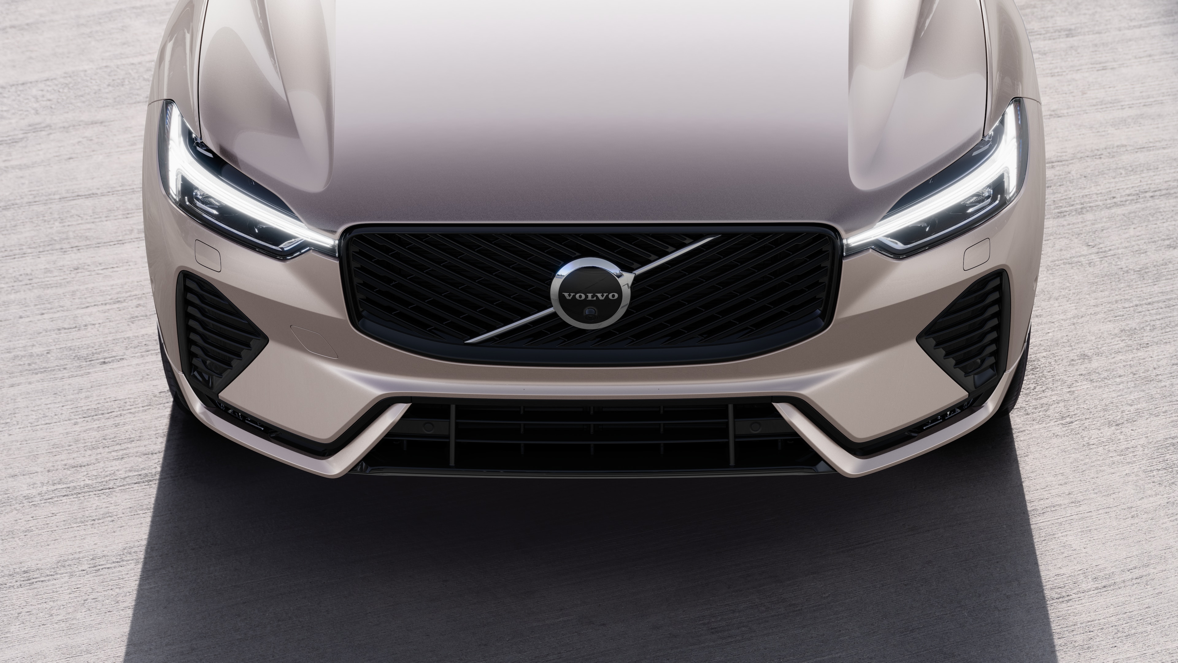 Volvo car exterior in three-quarter view on an urban street background, showing one side, roof, and part of the front.