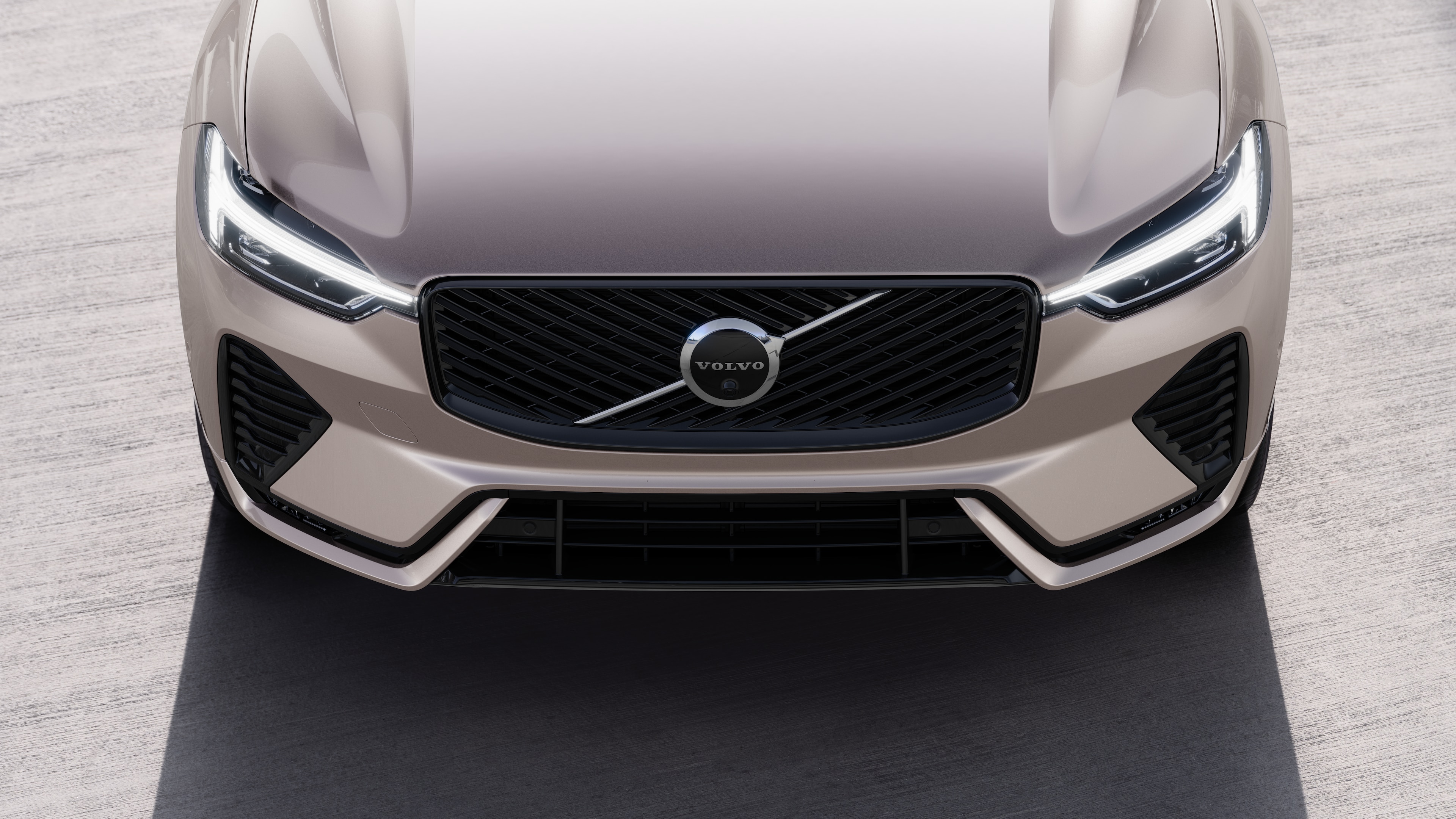 Volvo car exterior in three-quarter view on an urban street background, showing one side, roof, and part of the front.