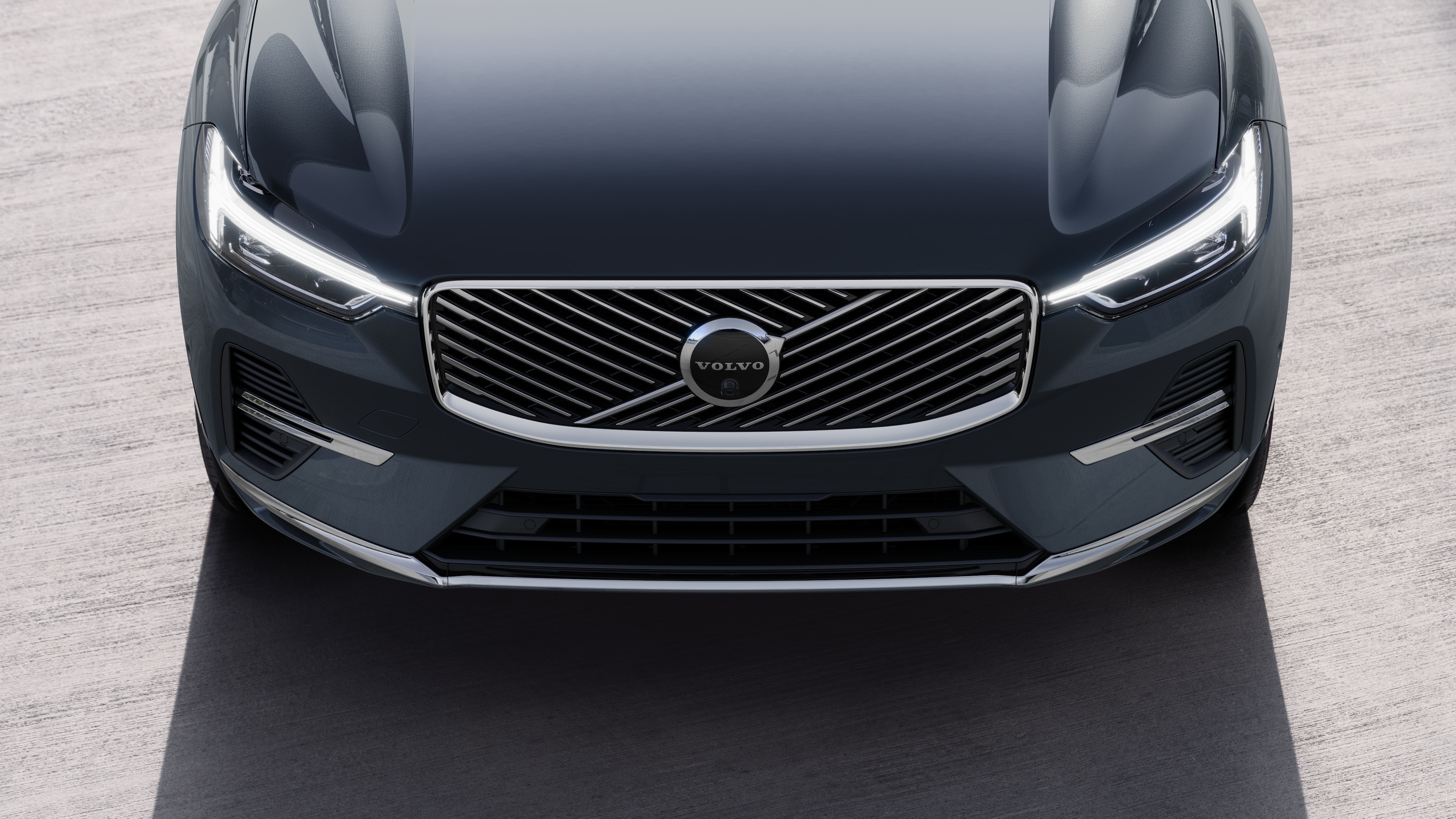 Volvo car exterior in three-quarter view on an urban street background, showing one side, roof, and part of the front.