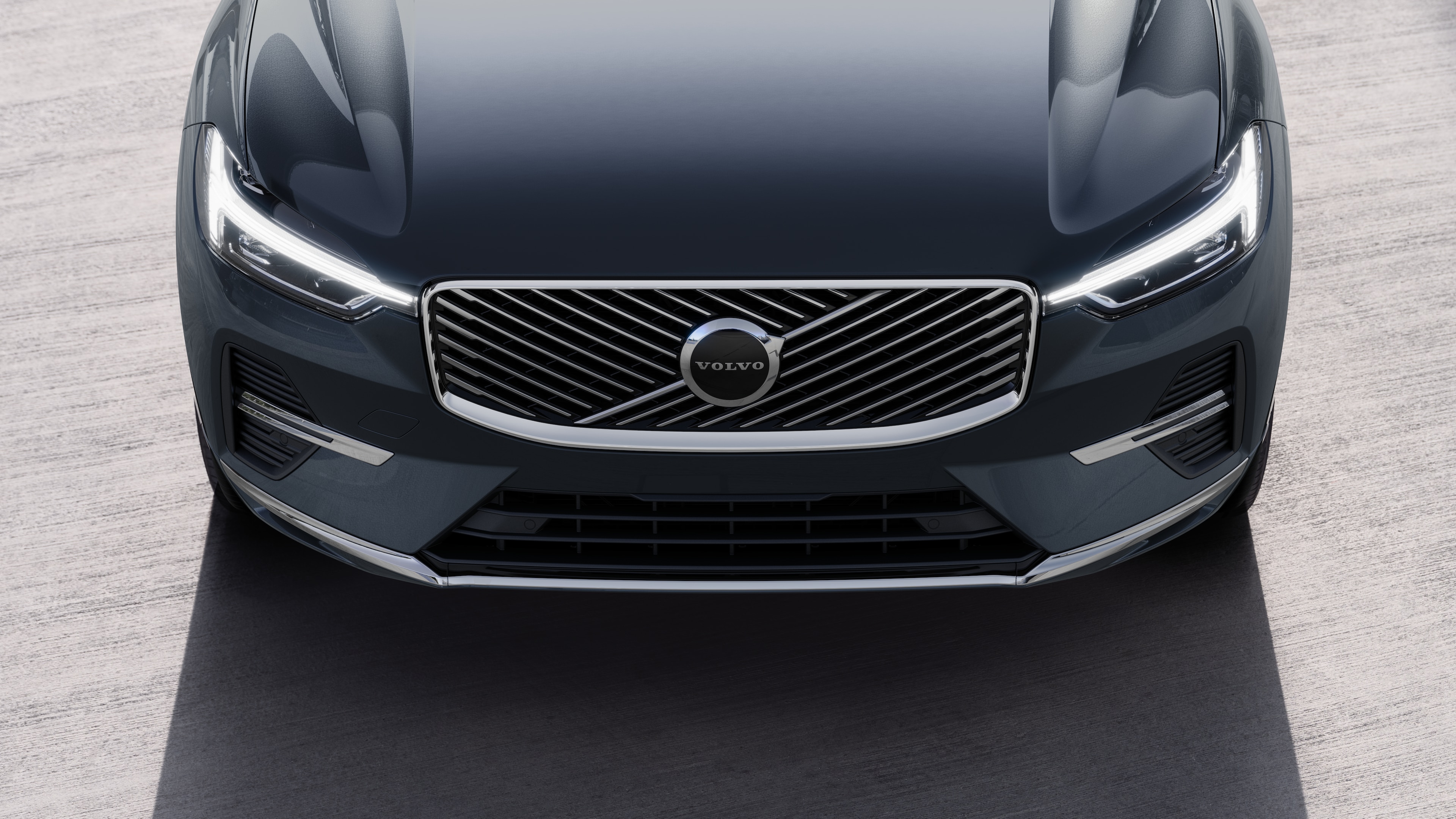 Volvo car exterior in three-quarter view on an urban street background, showing one side, roof, and part of the front.