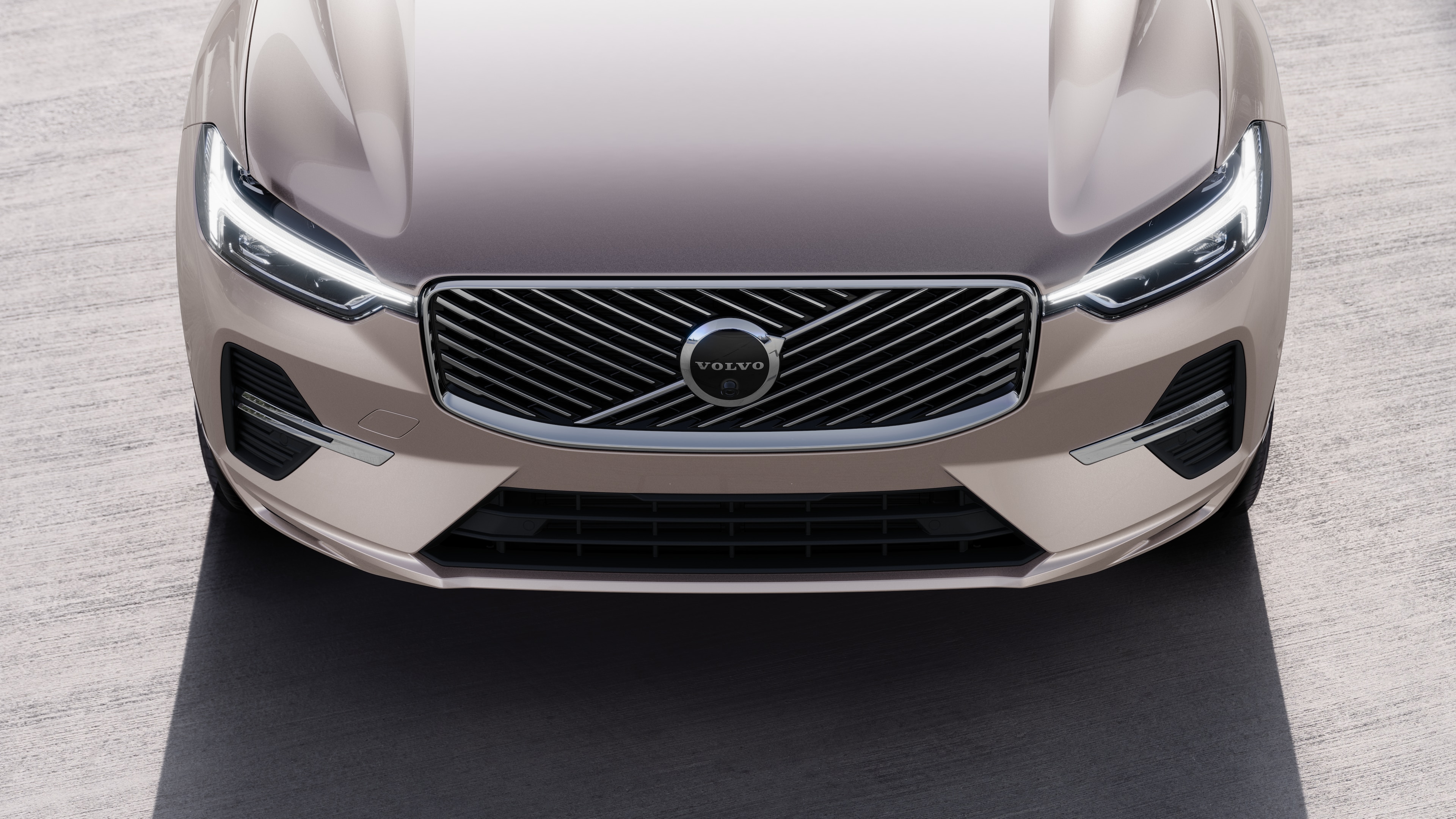 Volvo car exterior in three-quarter view on an urban street background, showing one side, roof, and part of the front.