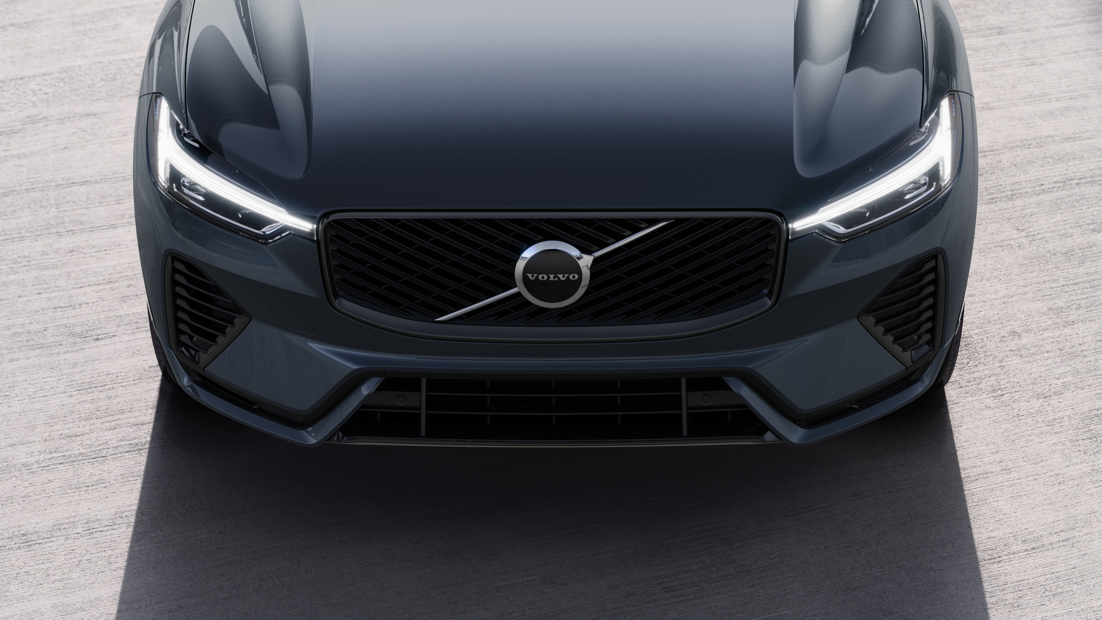 Volvo car exterior in three-quarter view on an urban street background, showing one side, roof, and part of the front.