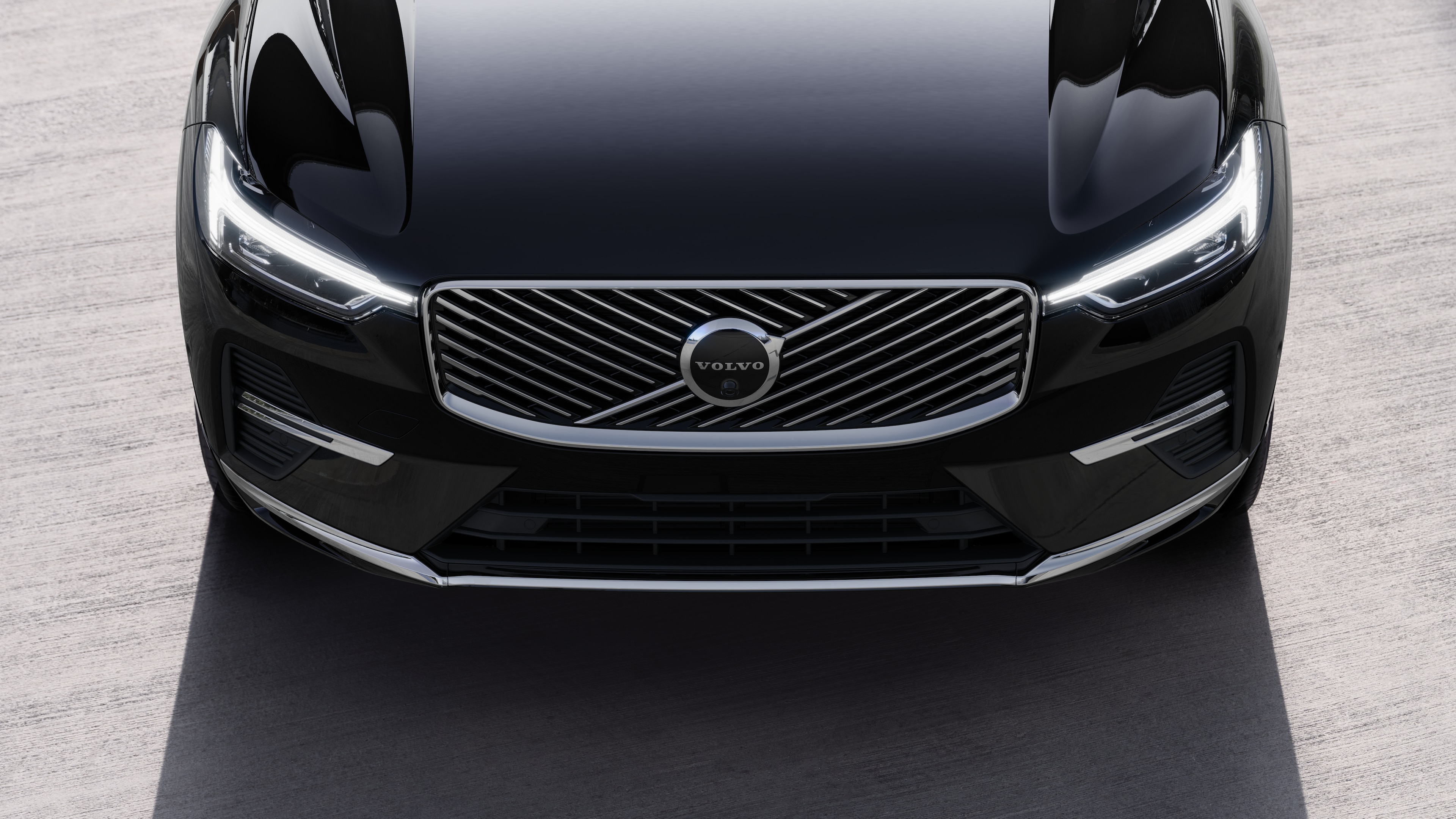 Volvo car exterior in three-quarter view on an urban street background, showing one side, roof, and part of the front.