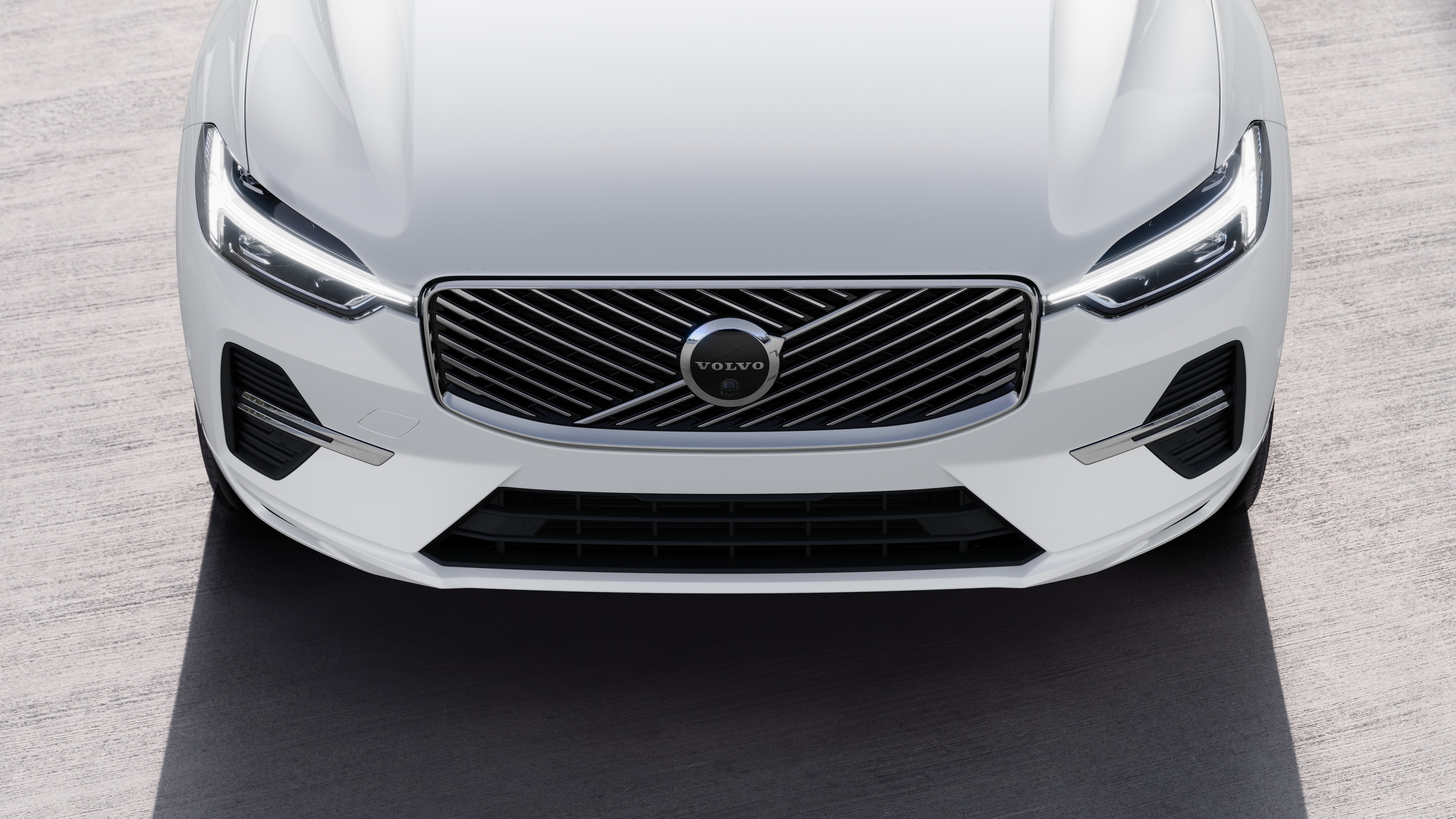 Volvo car exterior in three-quarter view on an urban street background, showing one side, roof, and part of the front.