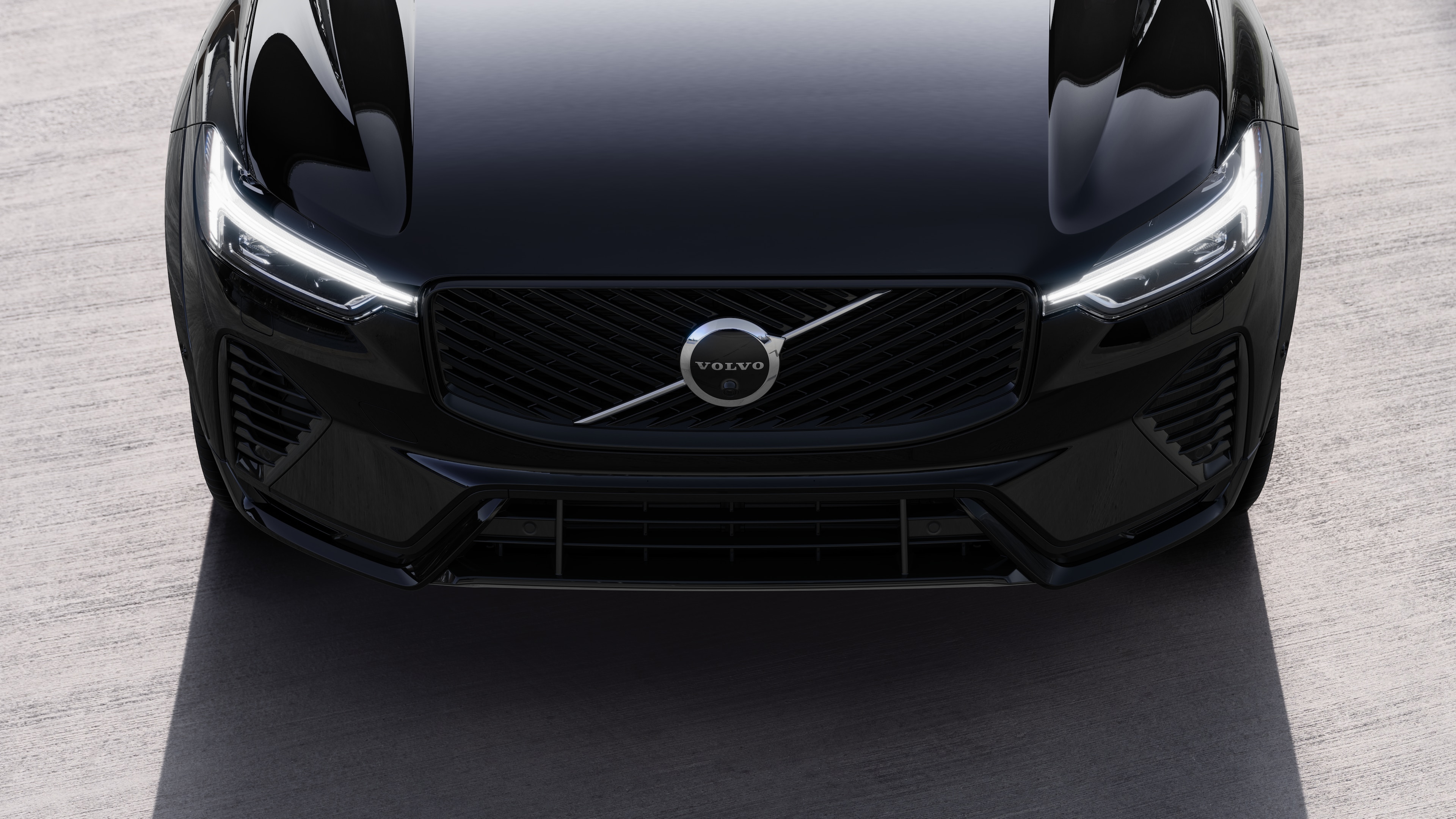 Volvo car exterior in three-quarter view on an urban street background, showing one side, roof, and part of the front.