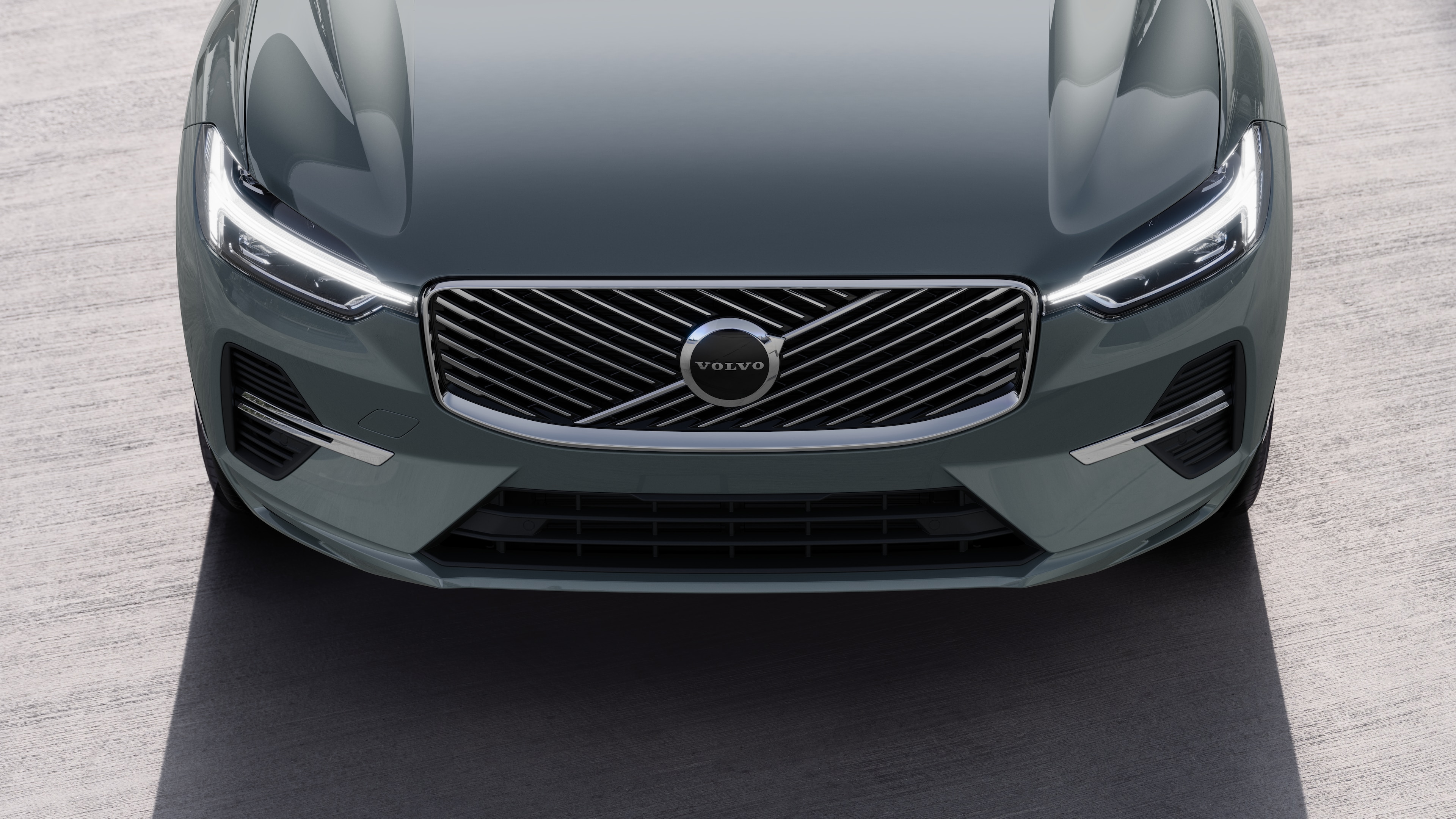 Volvo car exterior in three-quarter view on an urban street background, showing one side, roof, and part of the front.