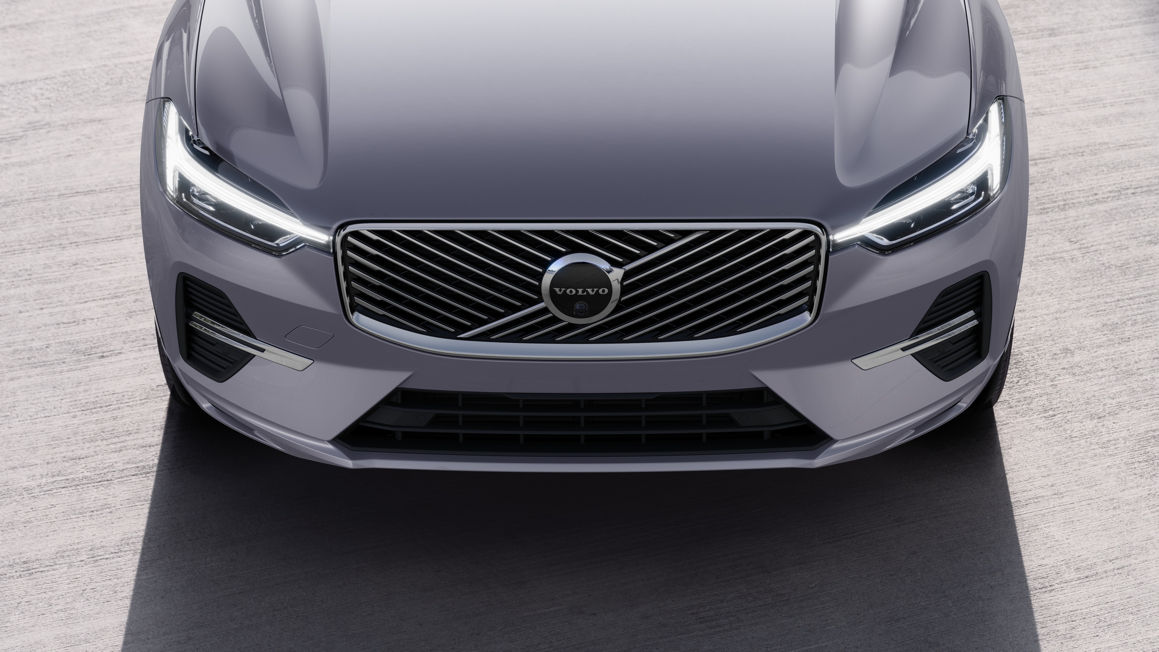 Volvo car exterior in three-quarter view on an urban street background, showing one side, roof, and part of the front.