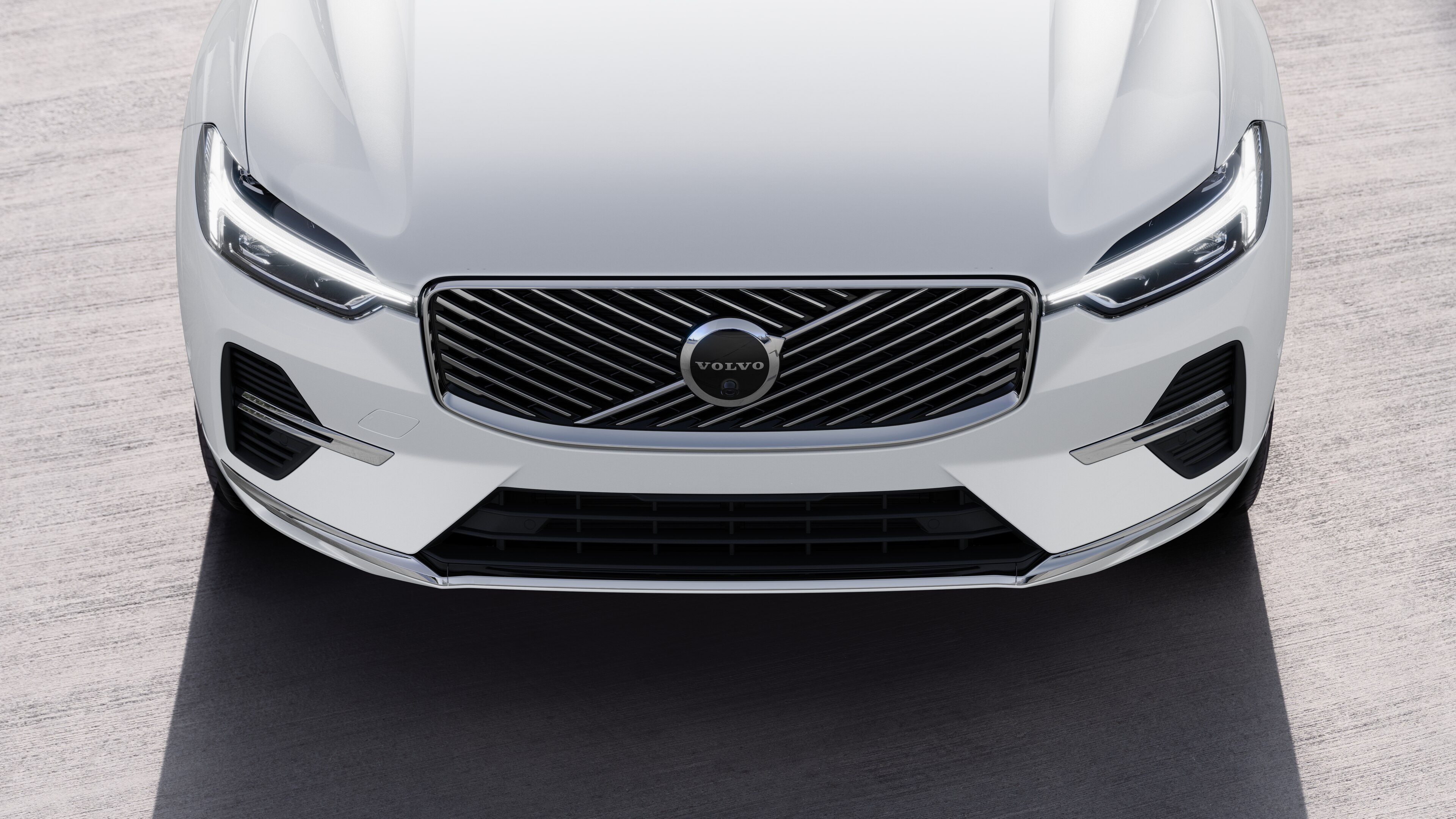 منظر خارجي لسيارة فولفو من ثلاثة أرباع سيارة فولفو على خلفية شارع حضري، يظهر جانبا واحدا وسقفا وجزءا من المقدمة.