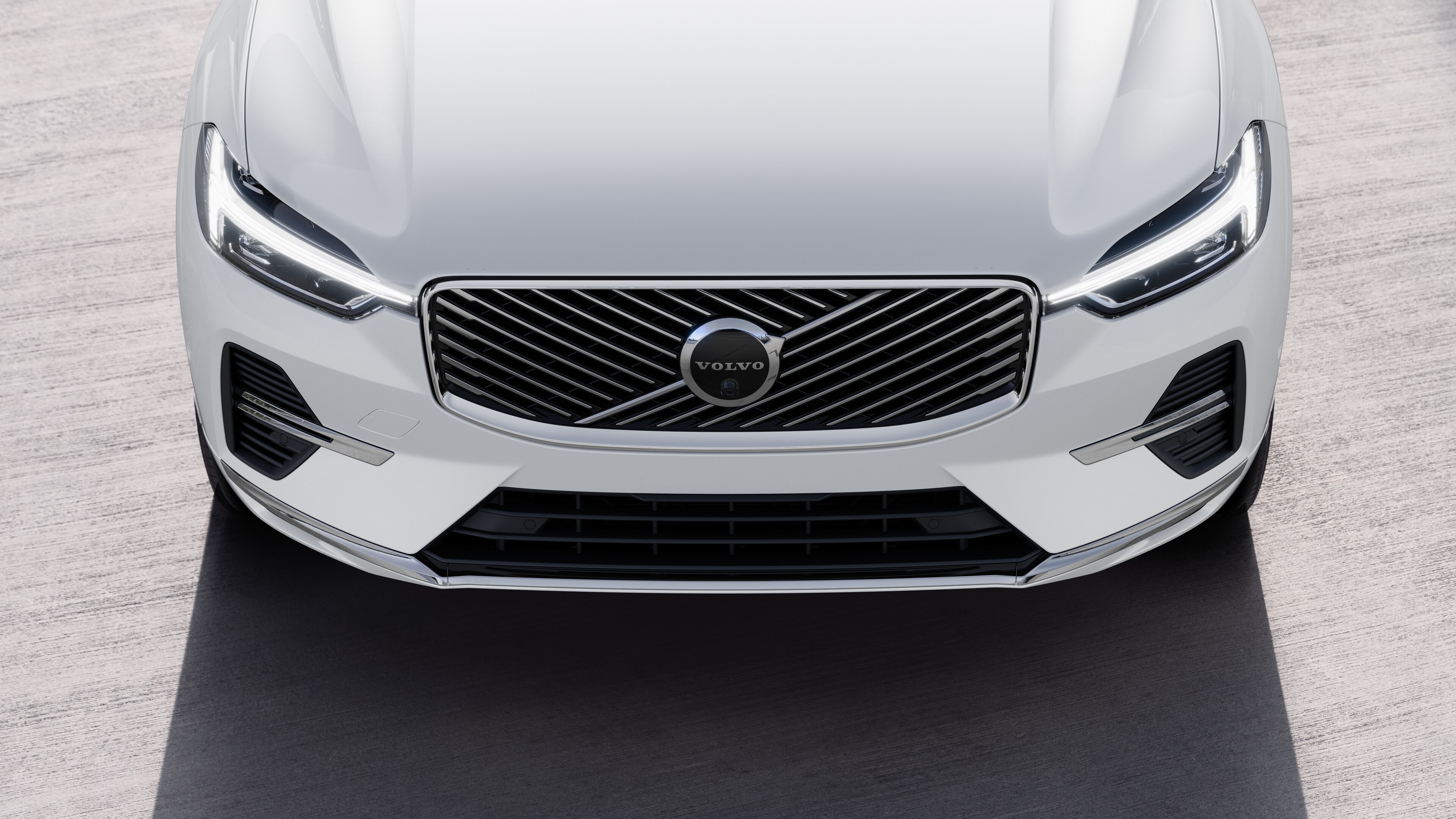 Volvo car exterior in three-quarter view on an urban street background, showing one side, roof, and part of the front.