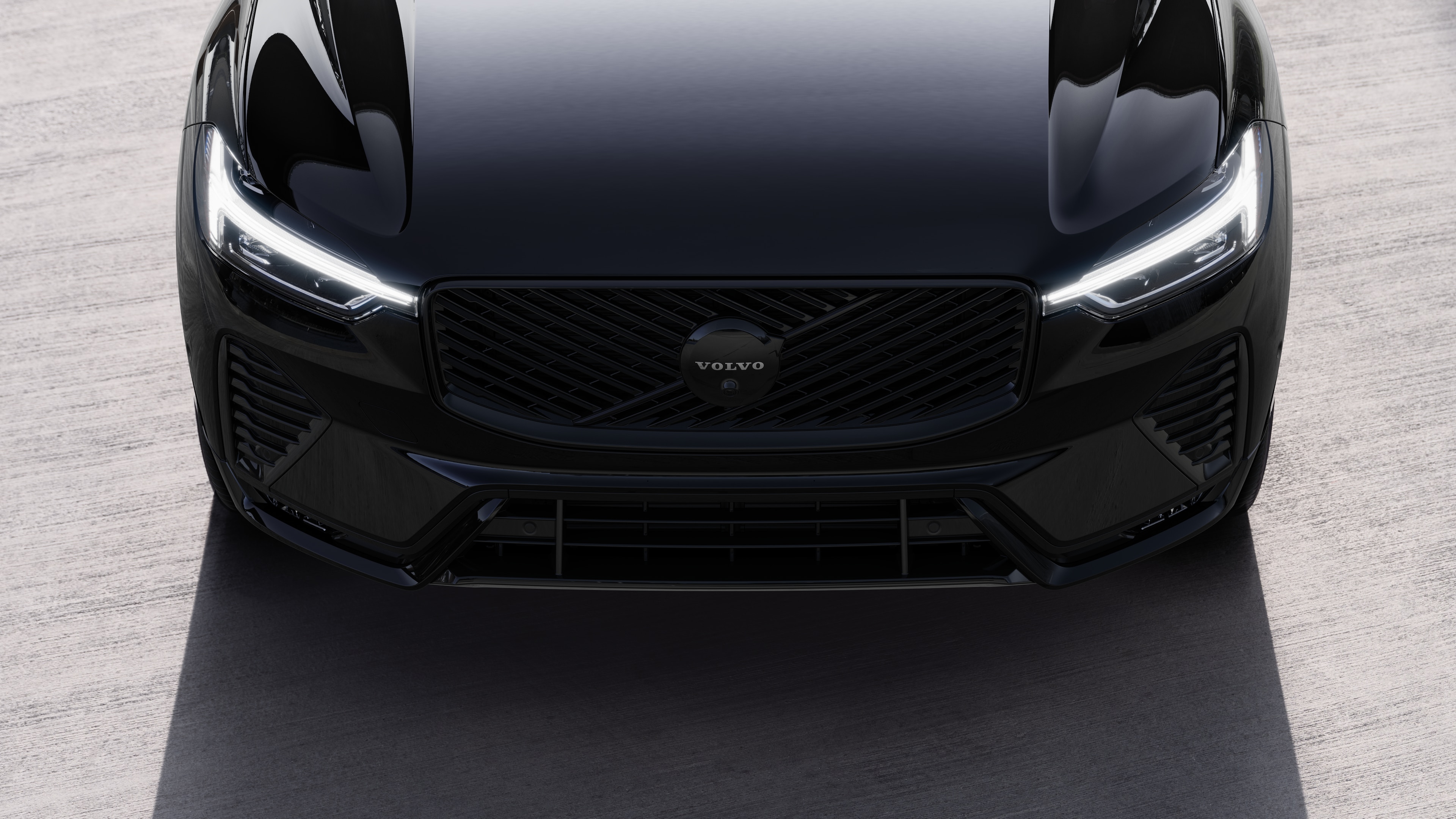 Volvo car exterior in three-quarter view on an urban street background, showing one side, roof, and part of the front.