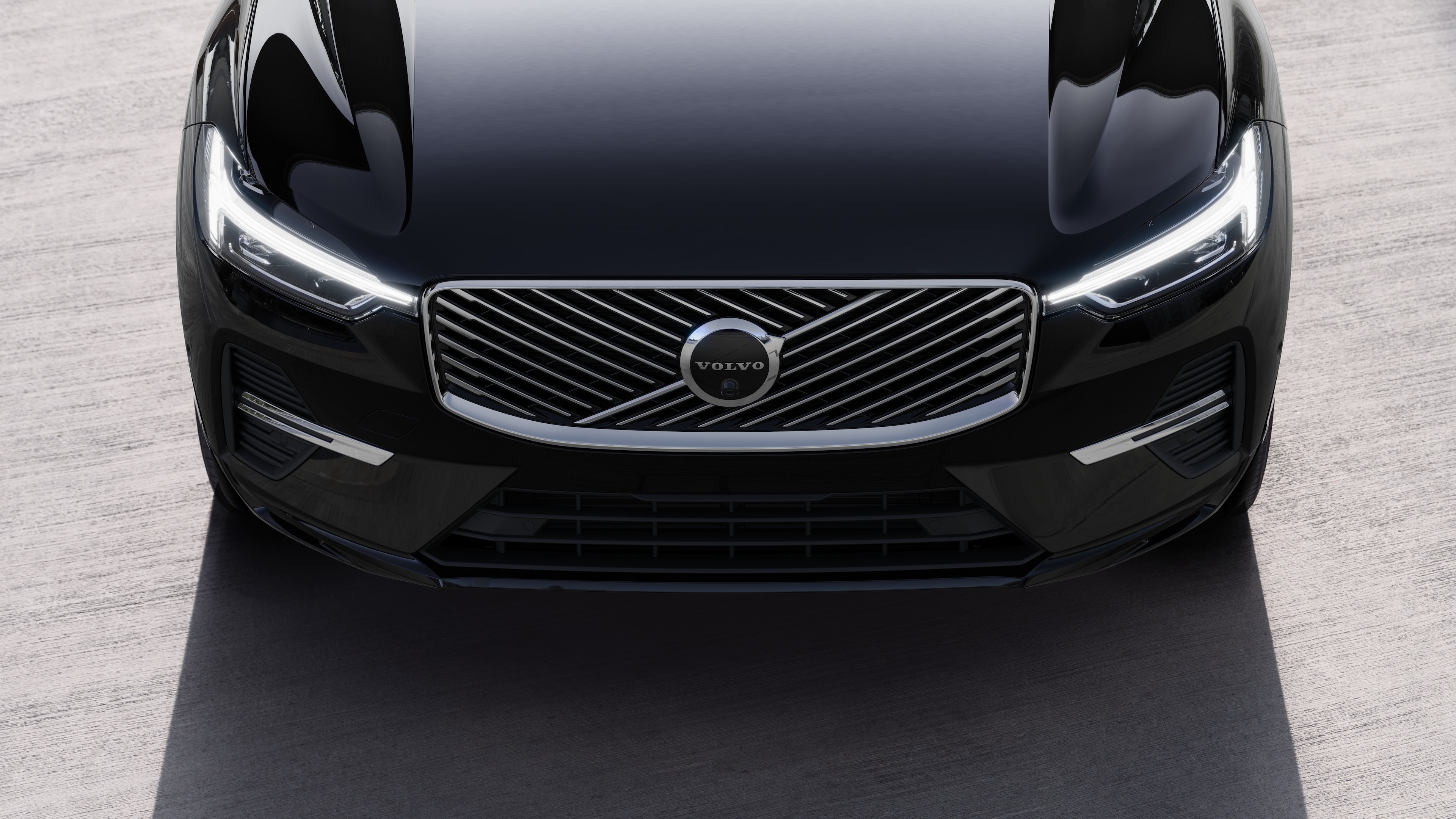 Volvo car exterior in three-quarter view on an urban street background, showing one side, roof, and part of the front.