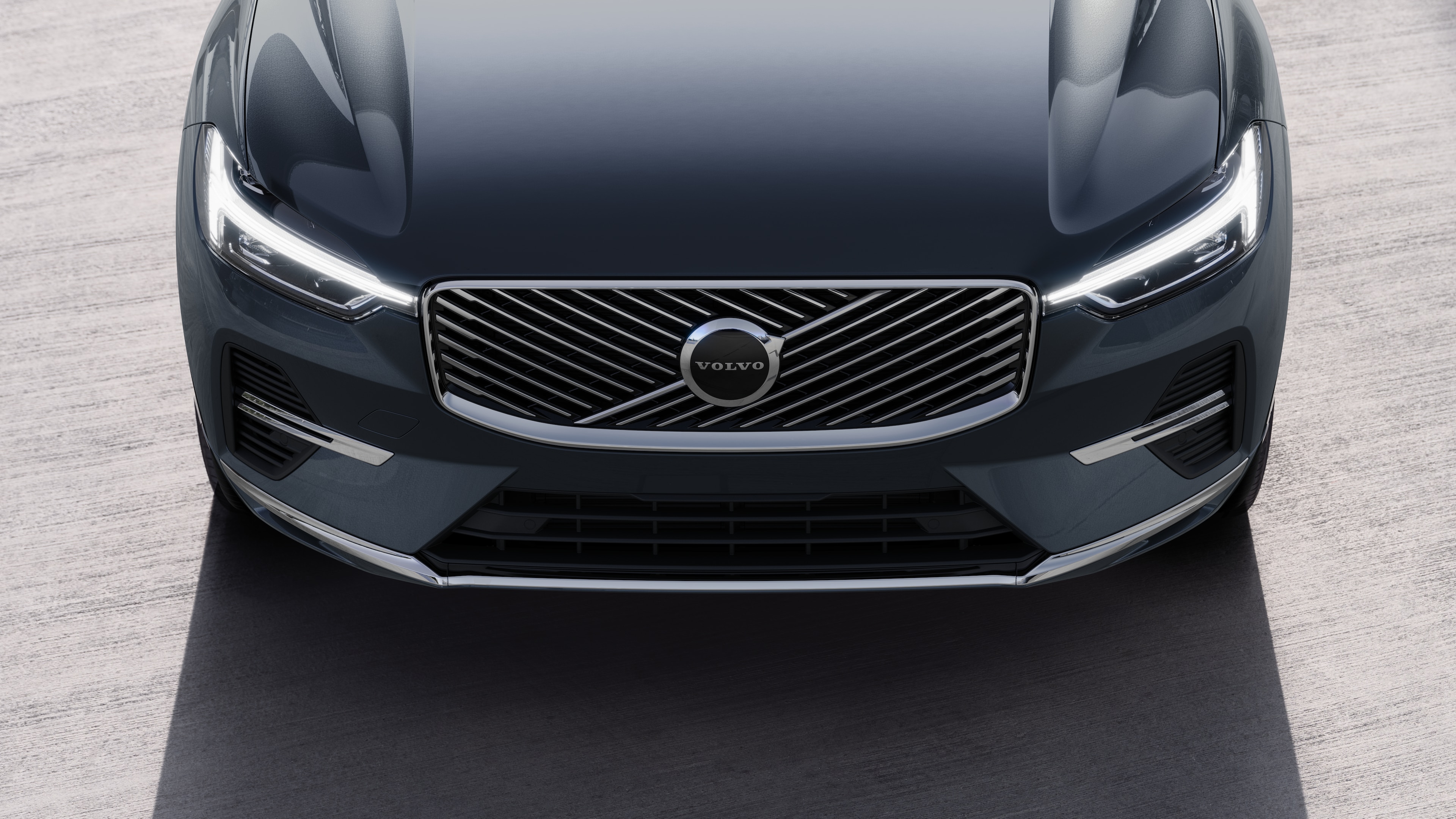 Volvo მანქანის ექსტერიერი სამი მეოთხედი ხედით ურბანული ქუჩის ფონზე, რომელიც აჩვენებს ერთ მხარეს, სახურავს და ფრონტის ნაწილს.