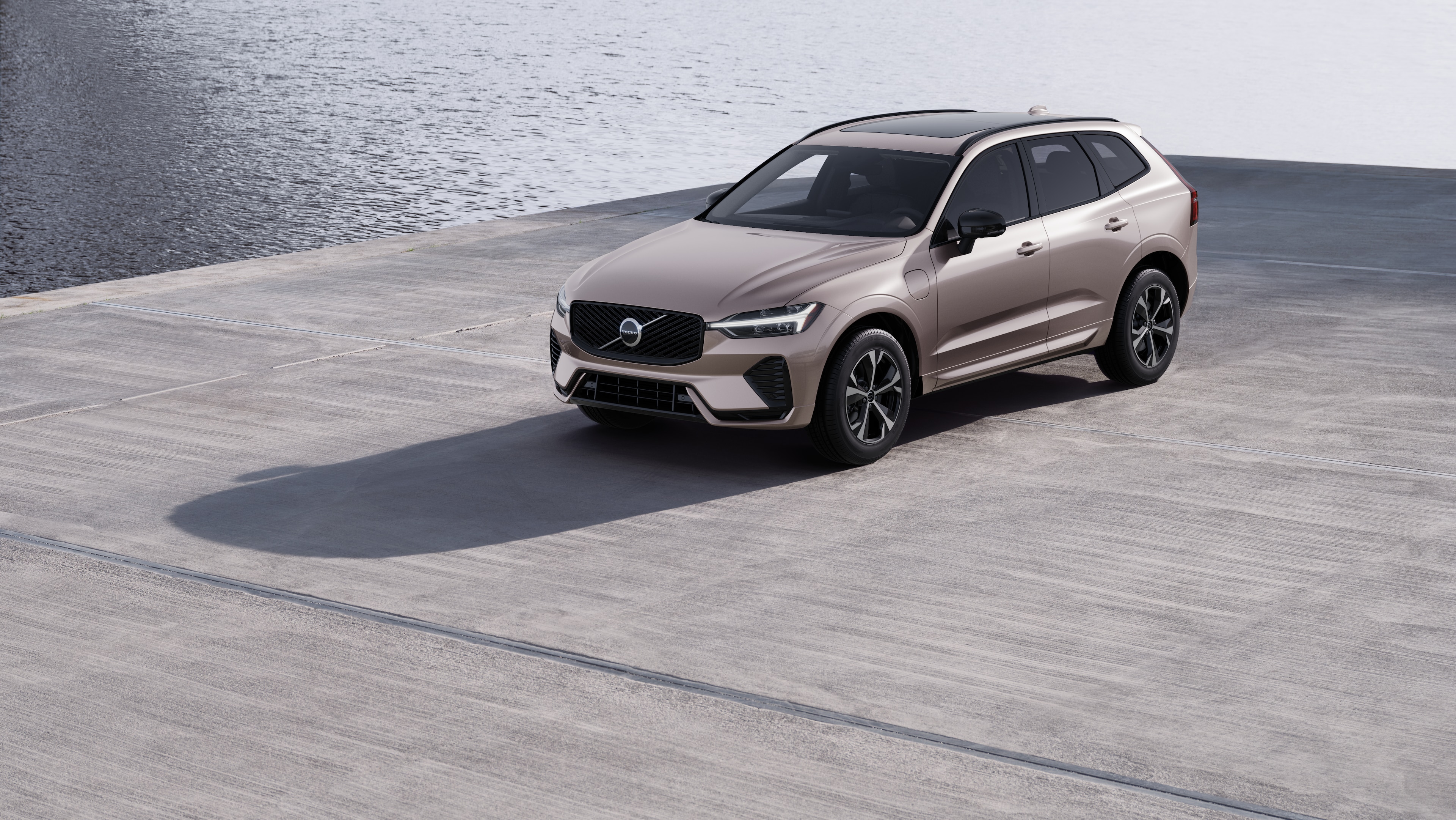Volvo car exterior in three-quarter view against an industrial concrete wall background.