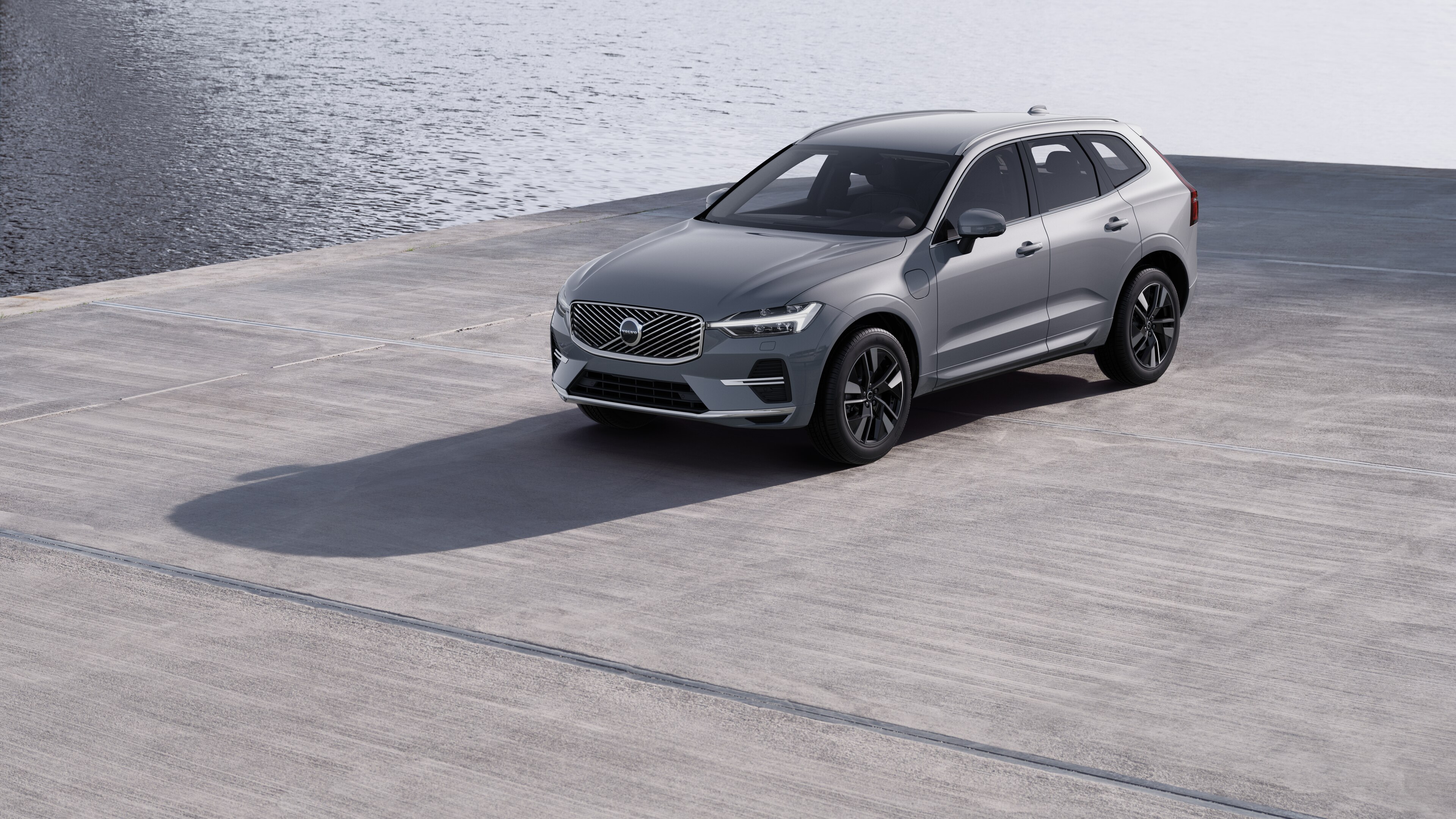 Volvobilens exteriör i trekvartsvy mot en industriell betongväggsbakgrund.