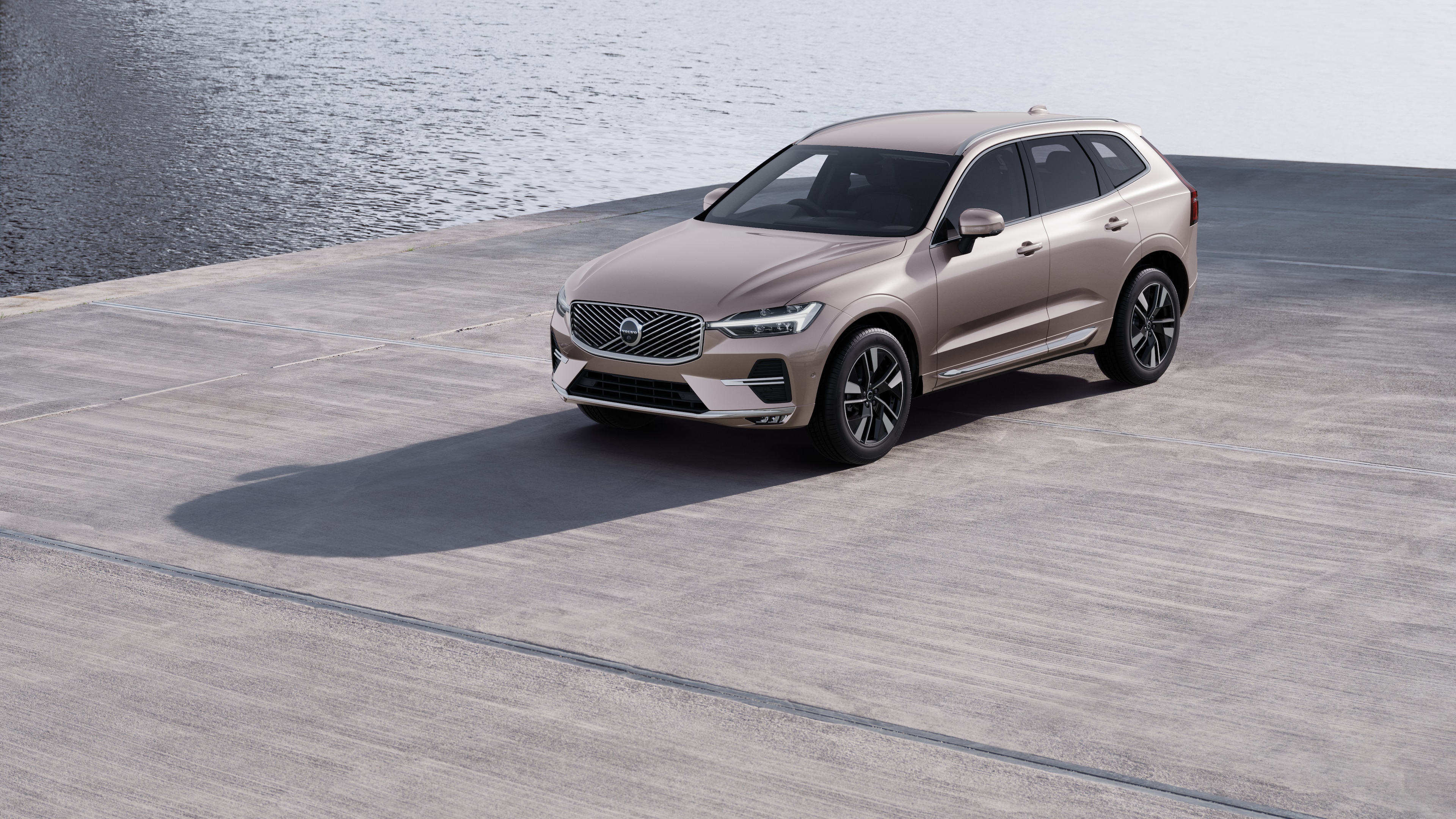 Volvo car exterior in three-quarter view against an industrial concrete wall background.