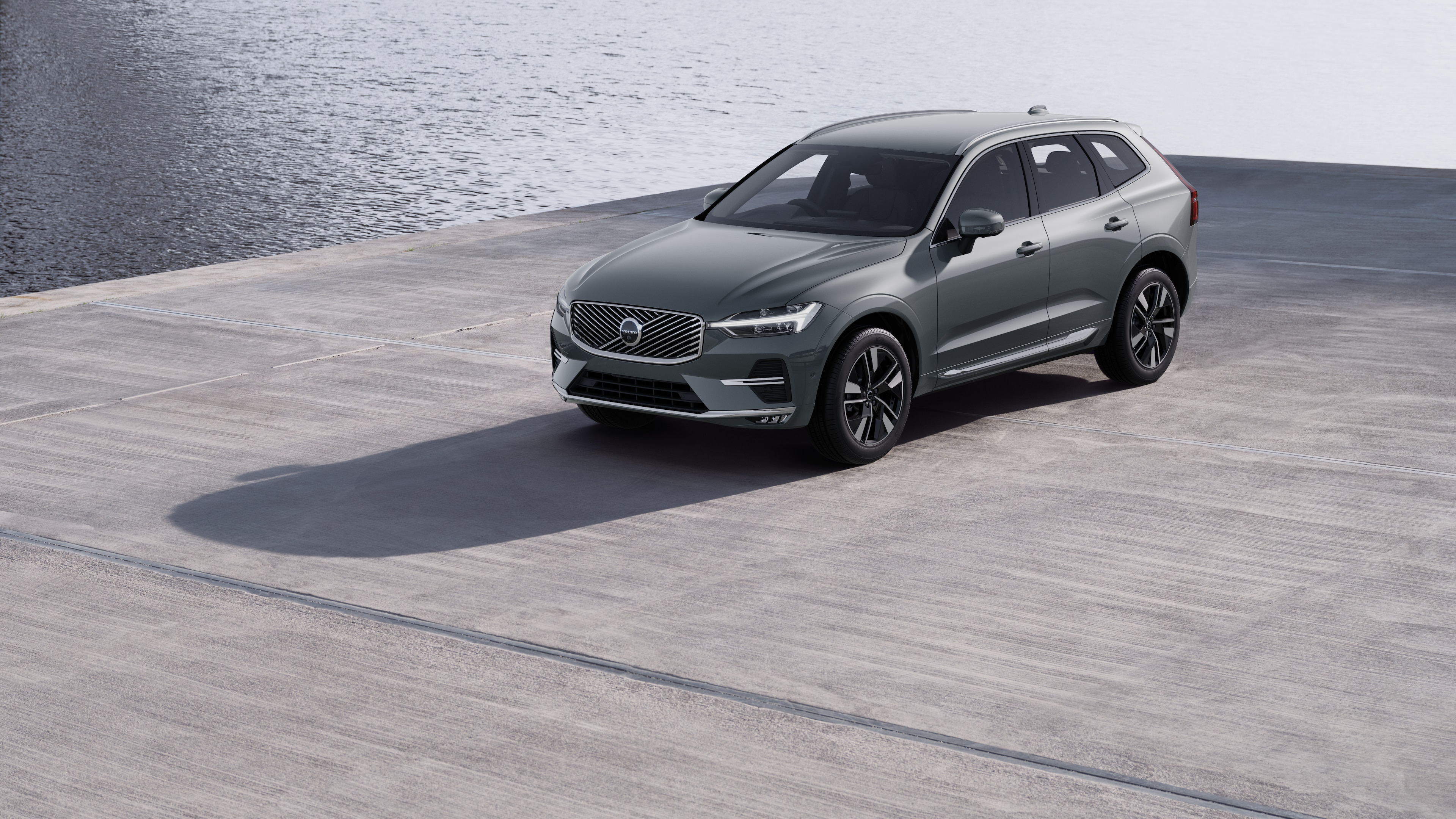 Volvo car exterior in three-quarter view against an industrial concrete wall background.