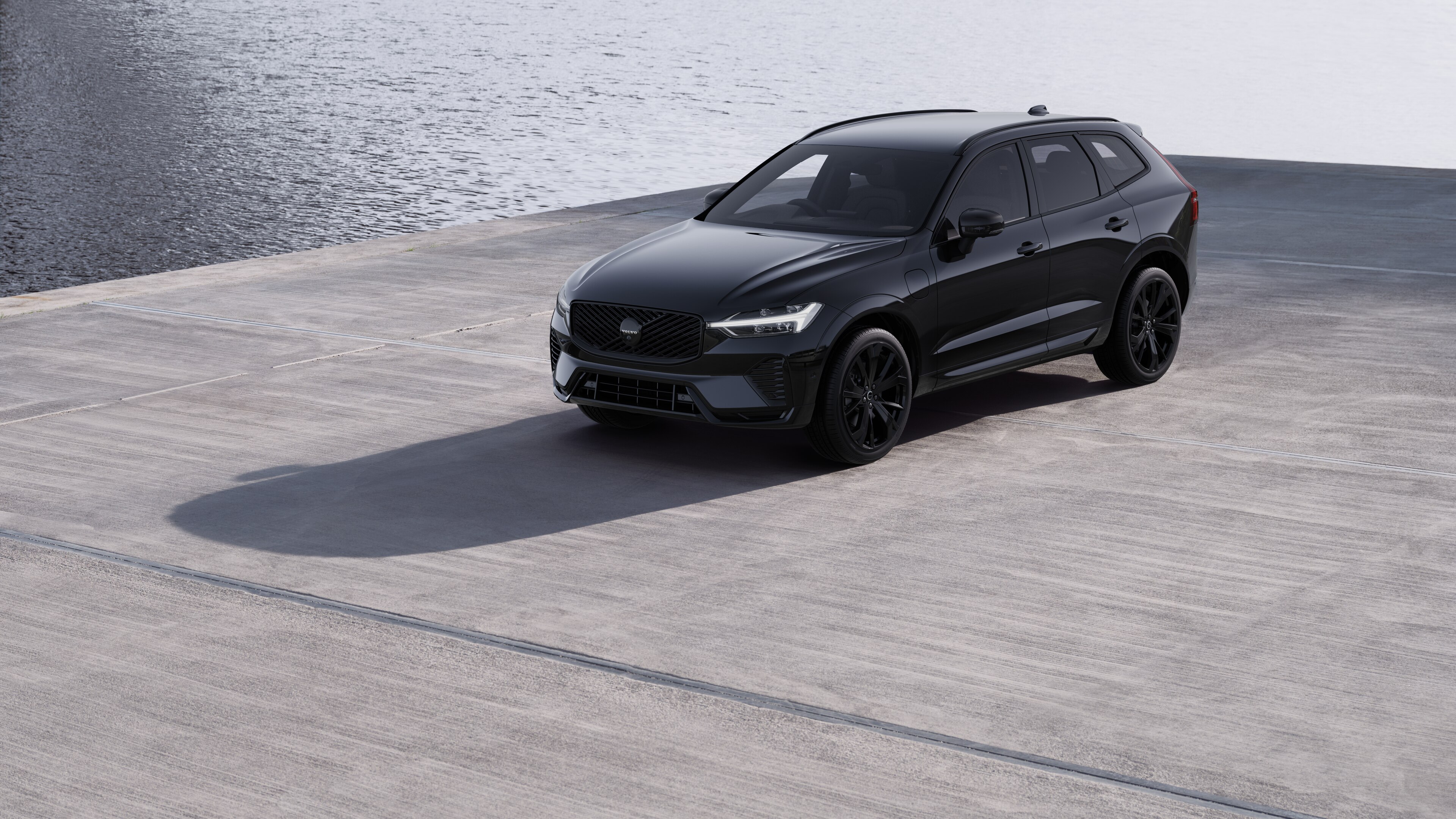 Volvo car exterior in three-quarter view against an industrial concrete wall background.