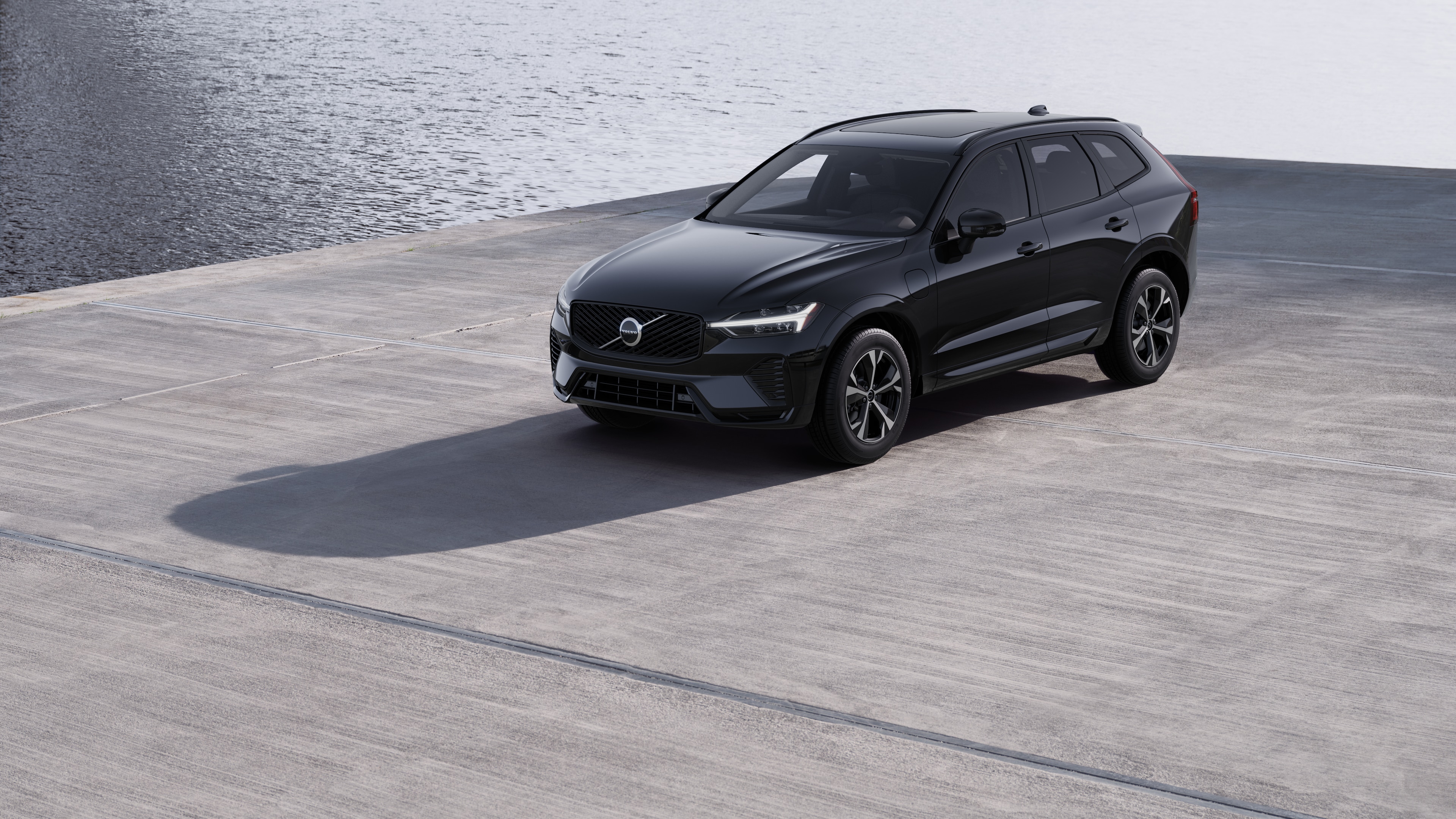 Volvo car exterior in three-quarter view against an industrial concrete wall background.