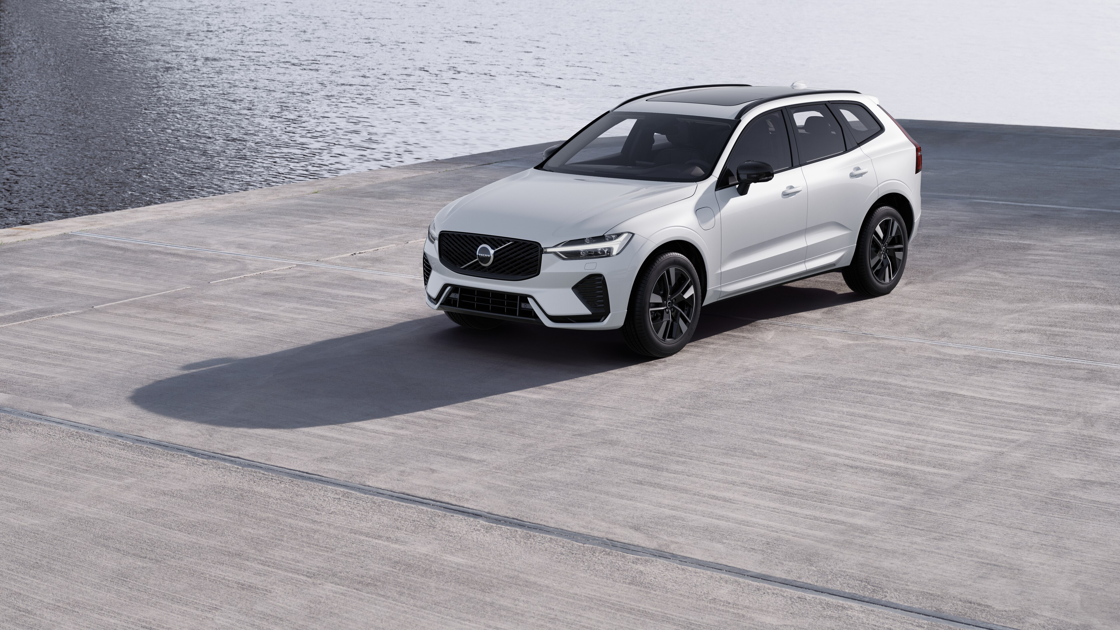 Vue de trois quarts de l’extérieur d’une Volvo sur un fond de mur industriel en béton.