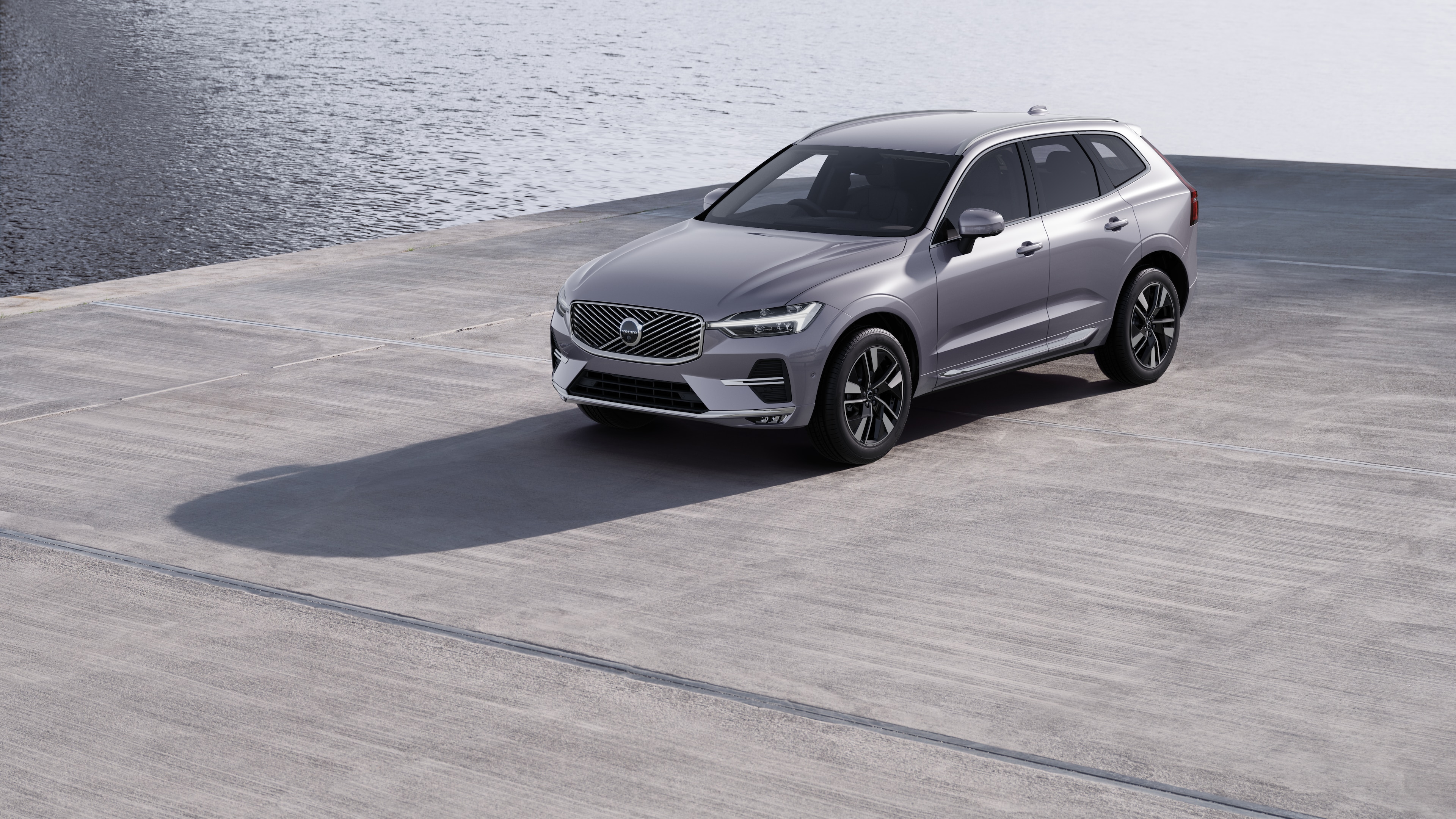Volvo car exterior in three-quarter view against an industrial concrete wall background.