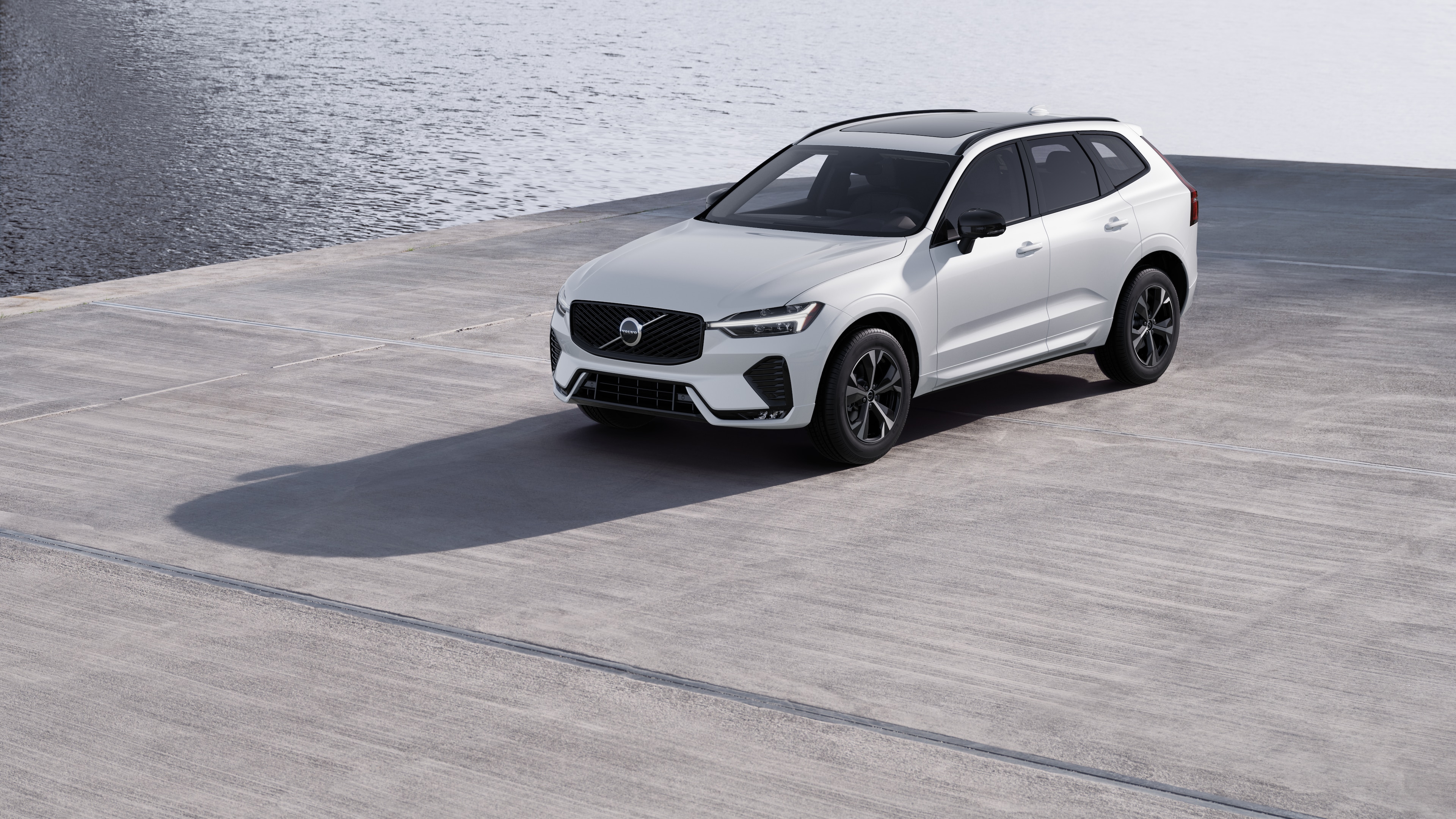 Volvo car exterior in three-quarter view against an industrial concrete wall background.