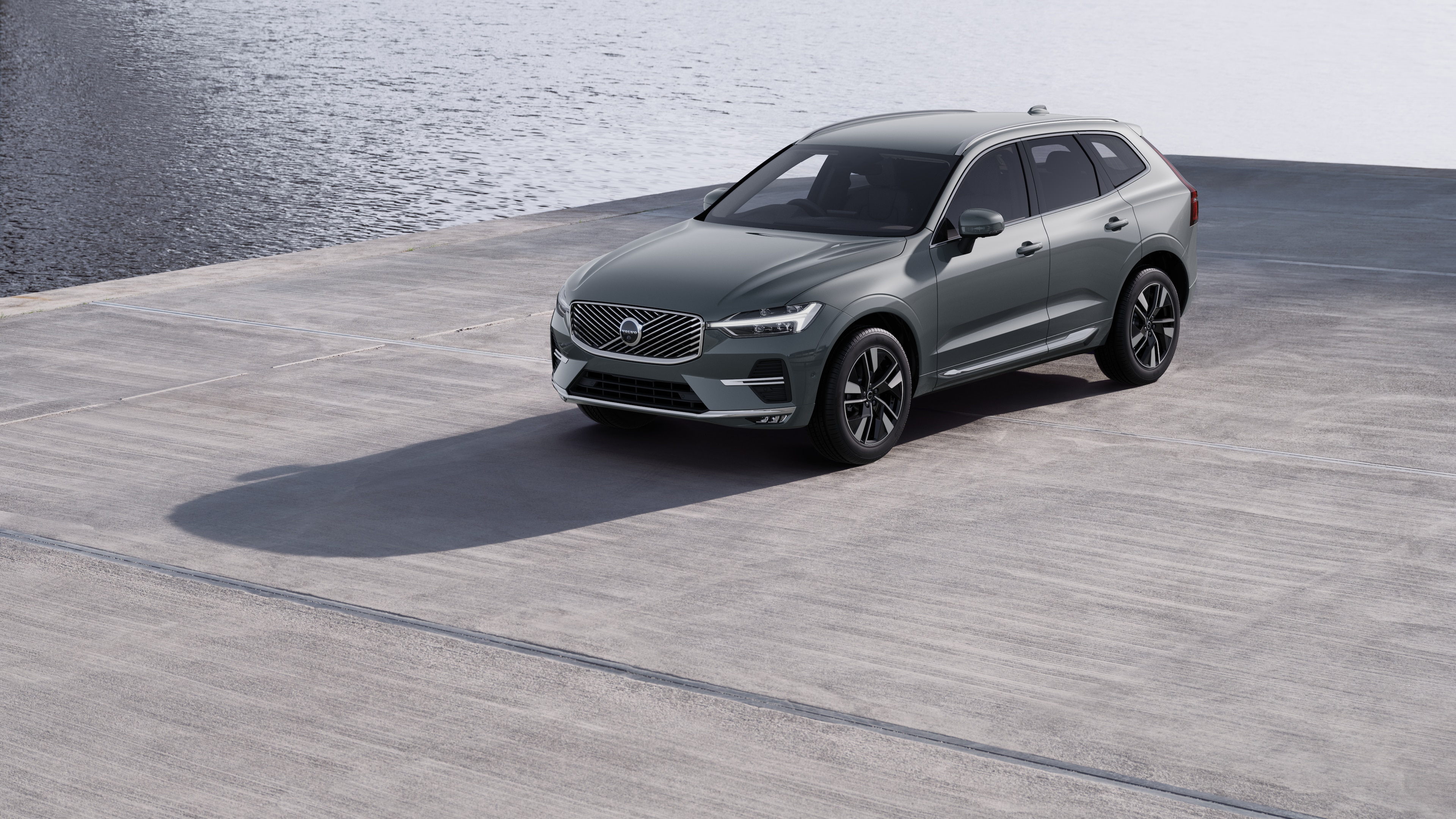 Volvo car exterior in three-quarter view against an industrial concrete wall background.