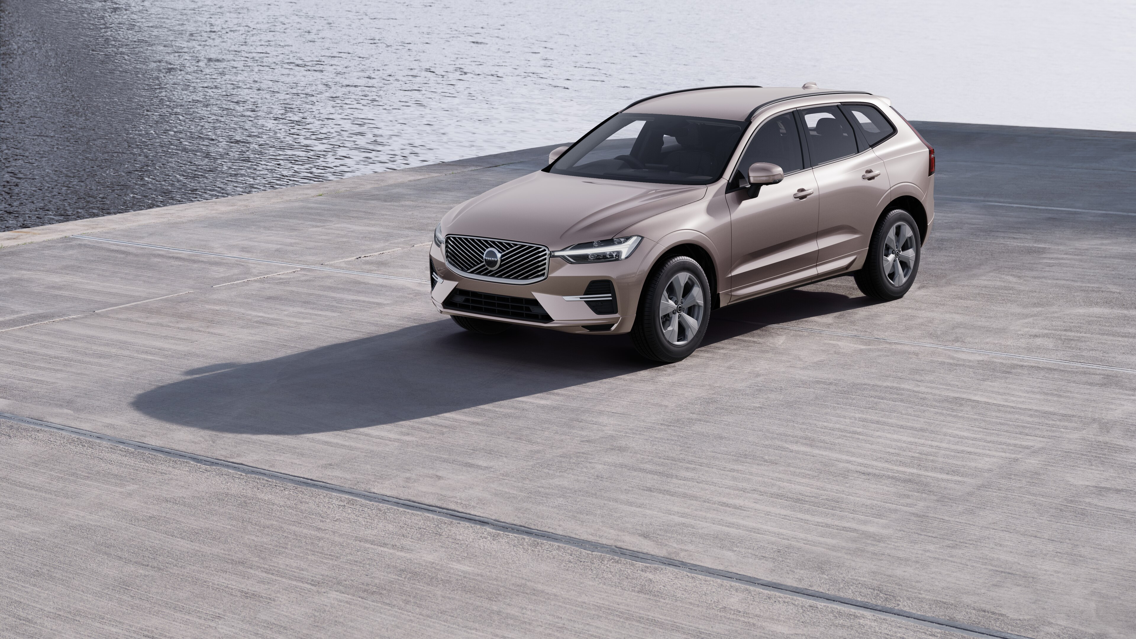 Volvo car exterior in three-quarter view against an industrial concrete wall background.