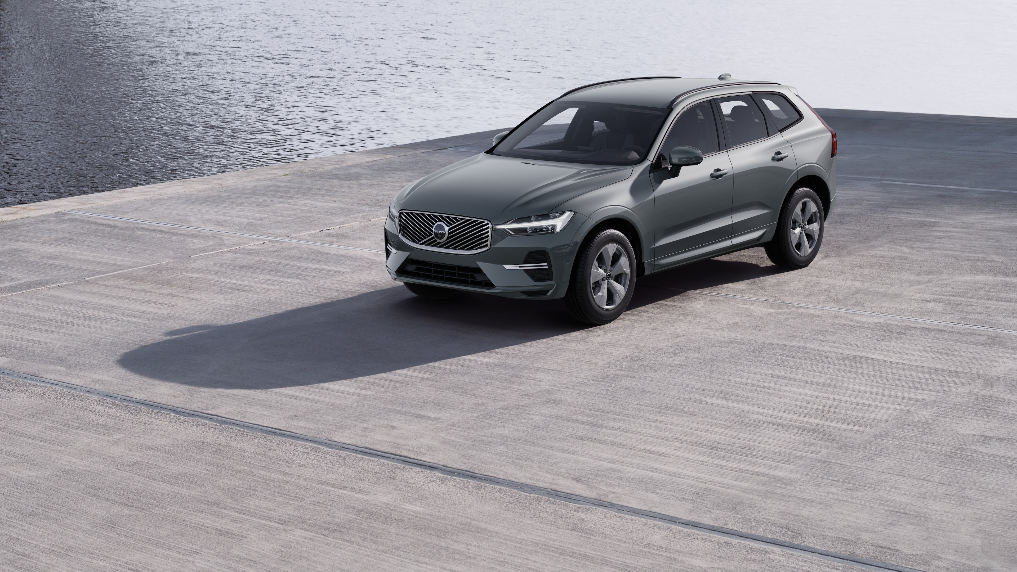 Volvo car exterior in three-quarter view against an industrial concrete wall background.