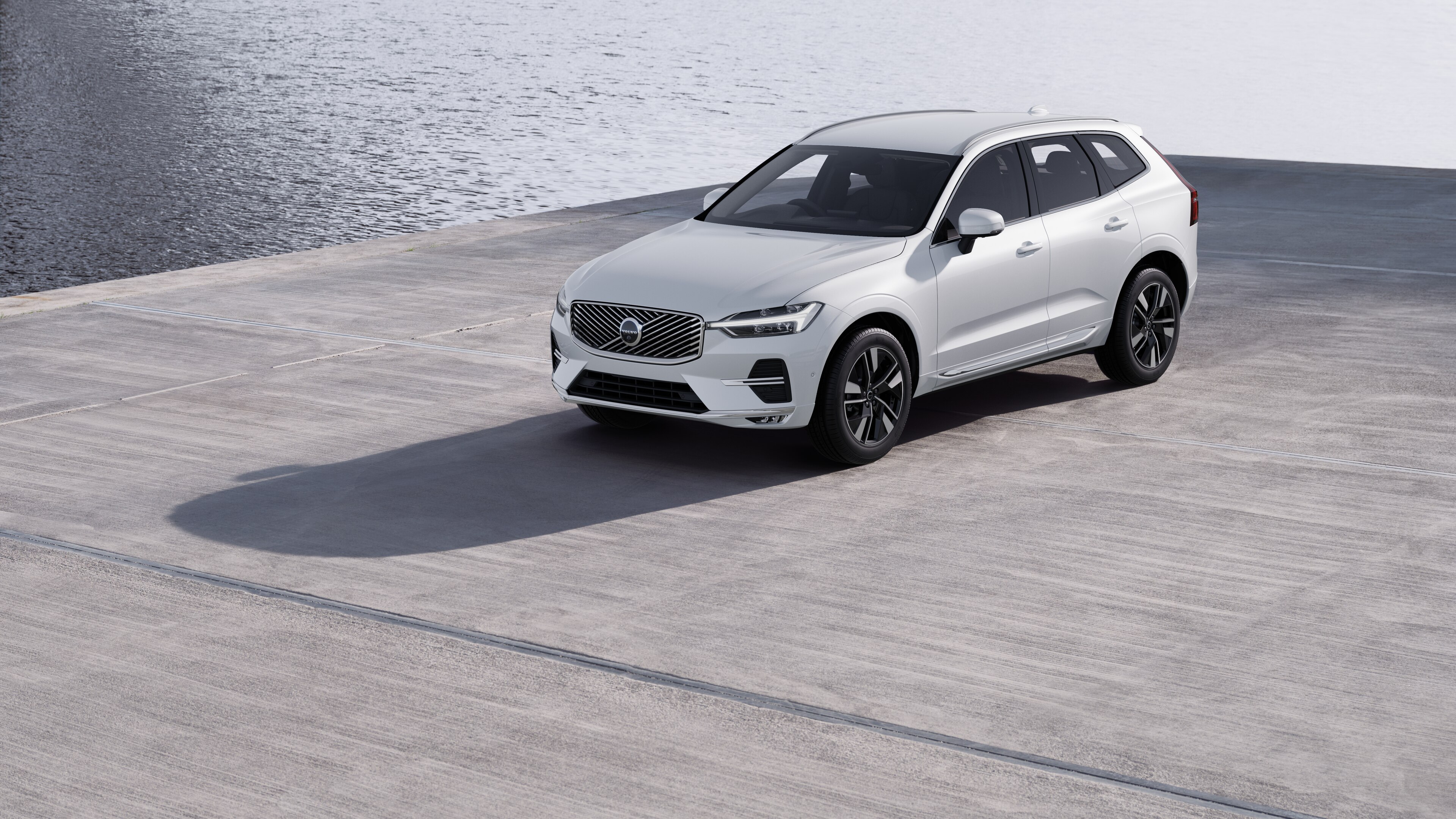 Volvo car exterior in three-quarter view against an industrial concrete wall background.