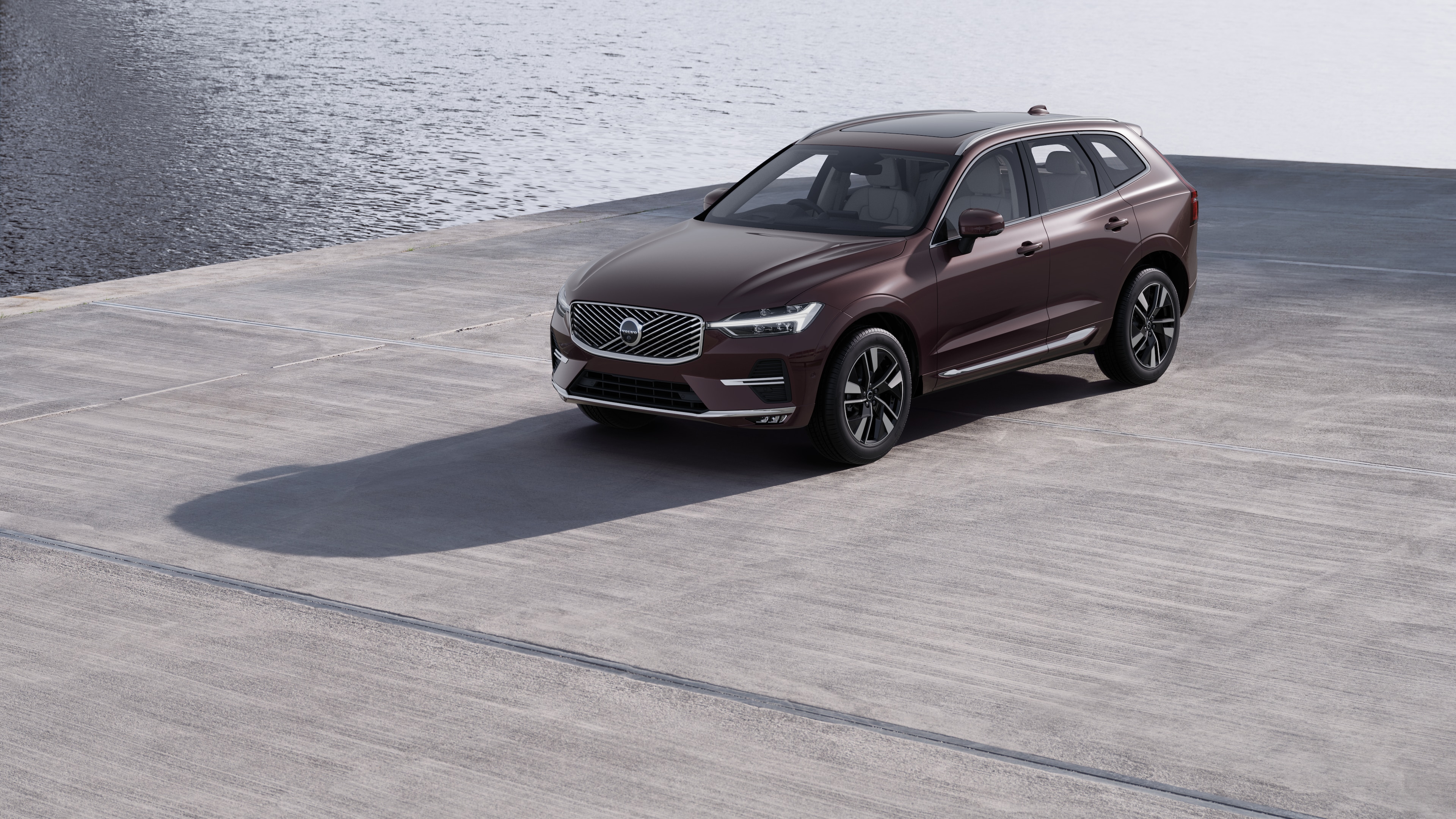 Volvo car exterior in three-quarter view against an industrial concrete wall background.