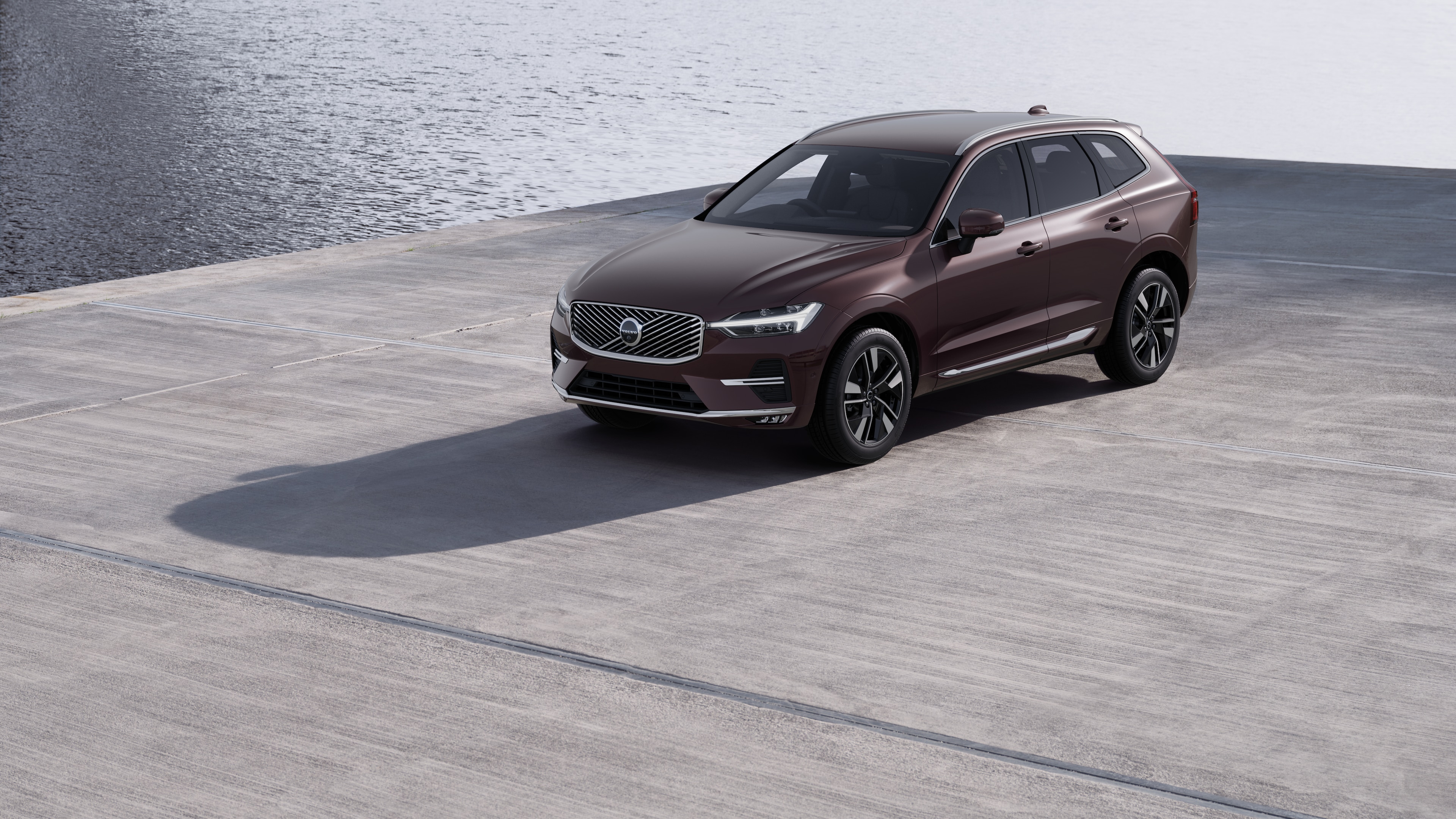 Volvo car exterior in three-quarter view against an industrial concrete wall background.