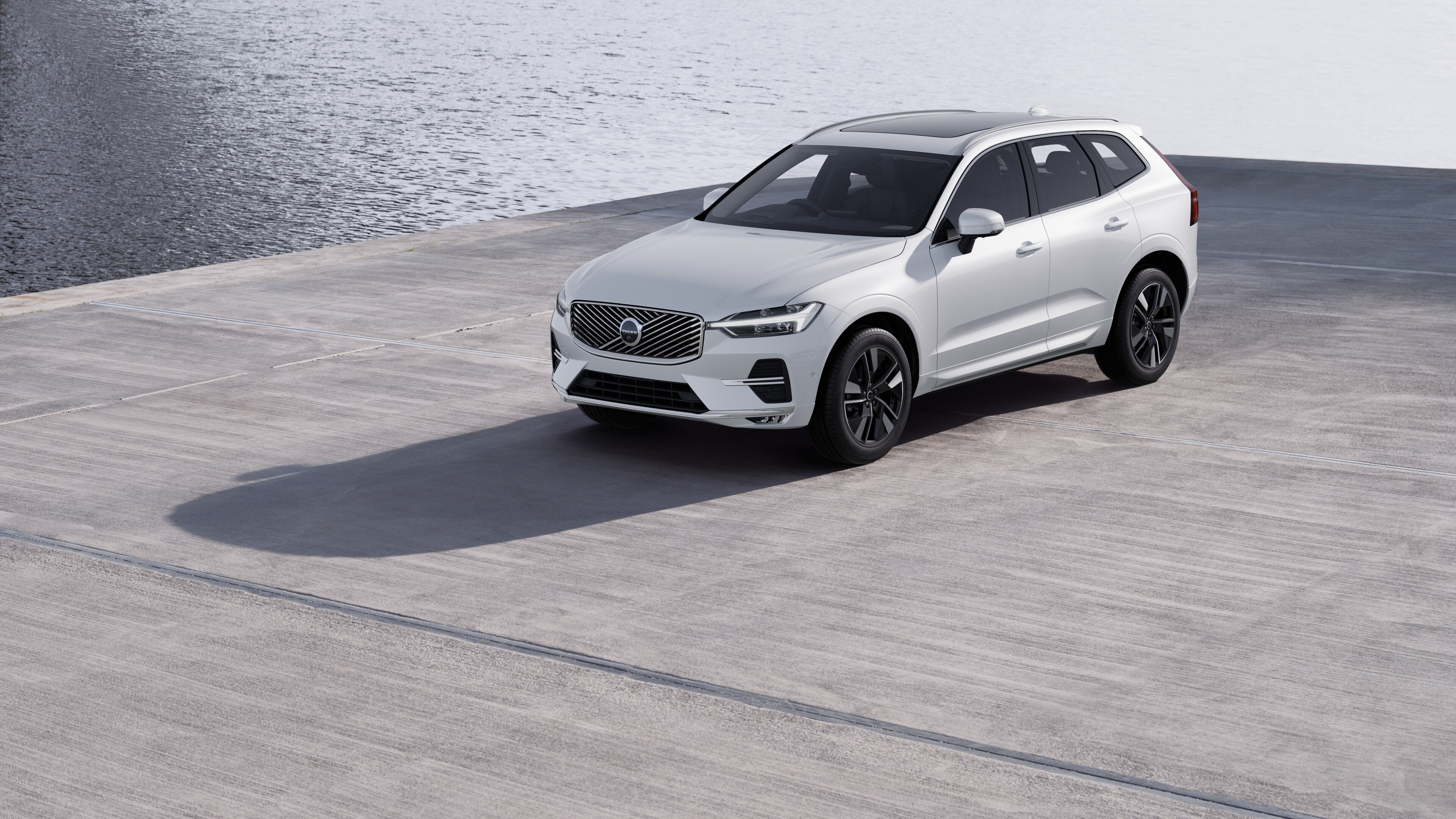 Volvo car exterior in three-quarter view against an industrial concrete wall background.