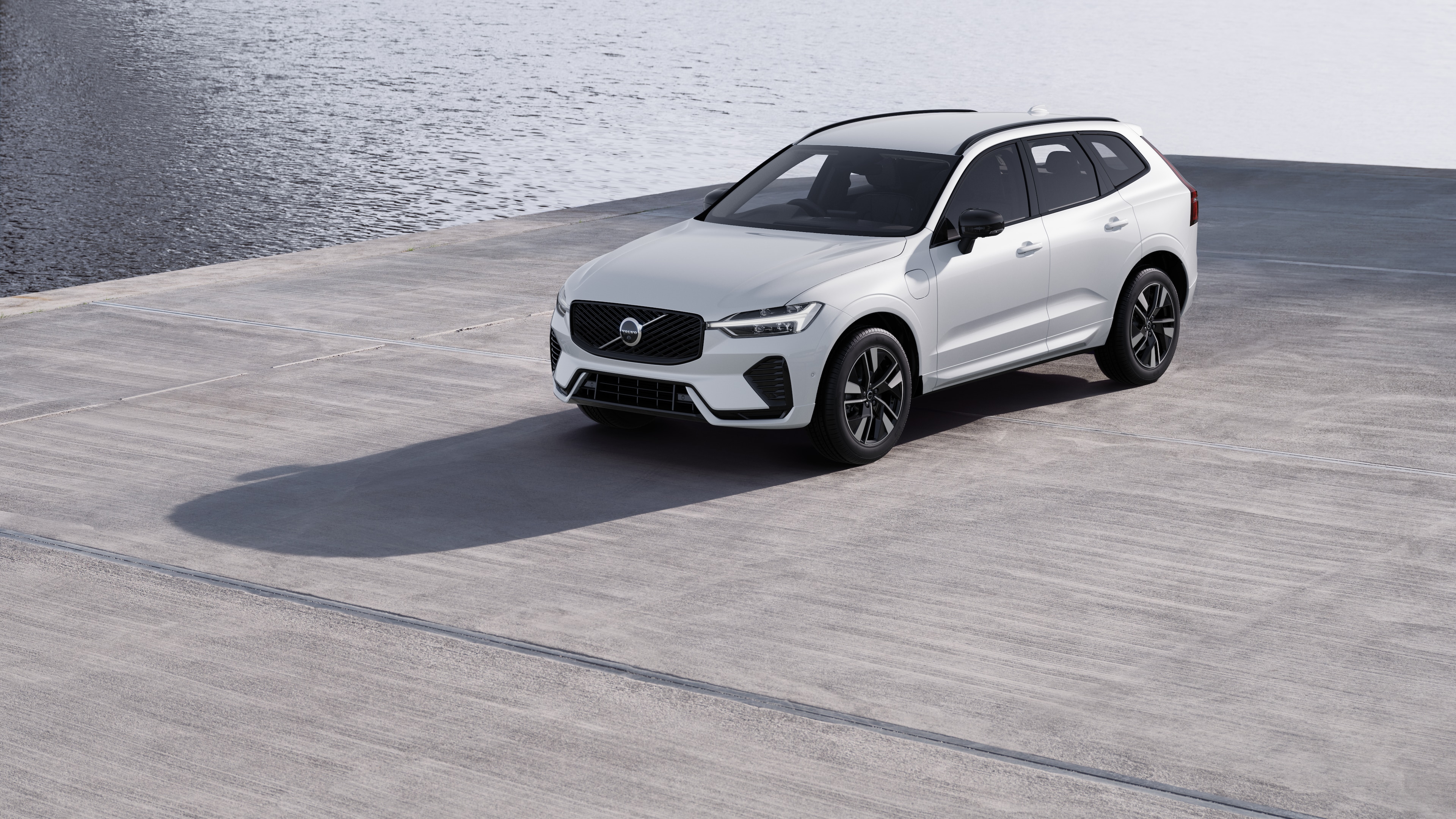 Volvo car exterior in three-quarter view against an industrial concrete wall background.