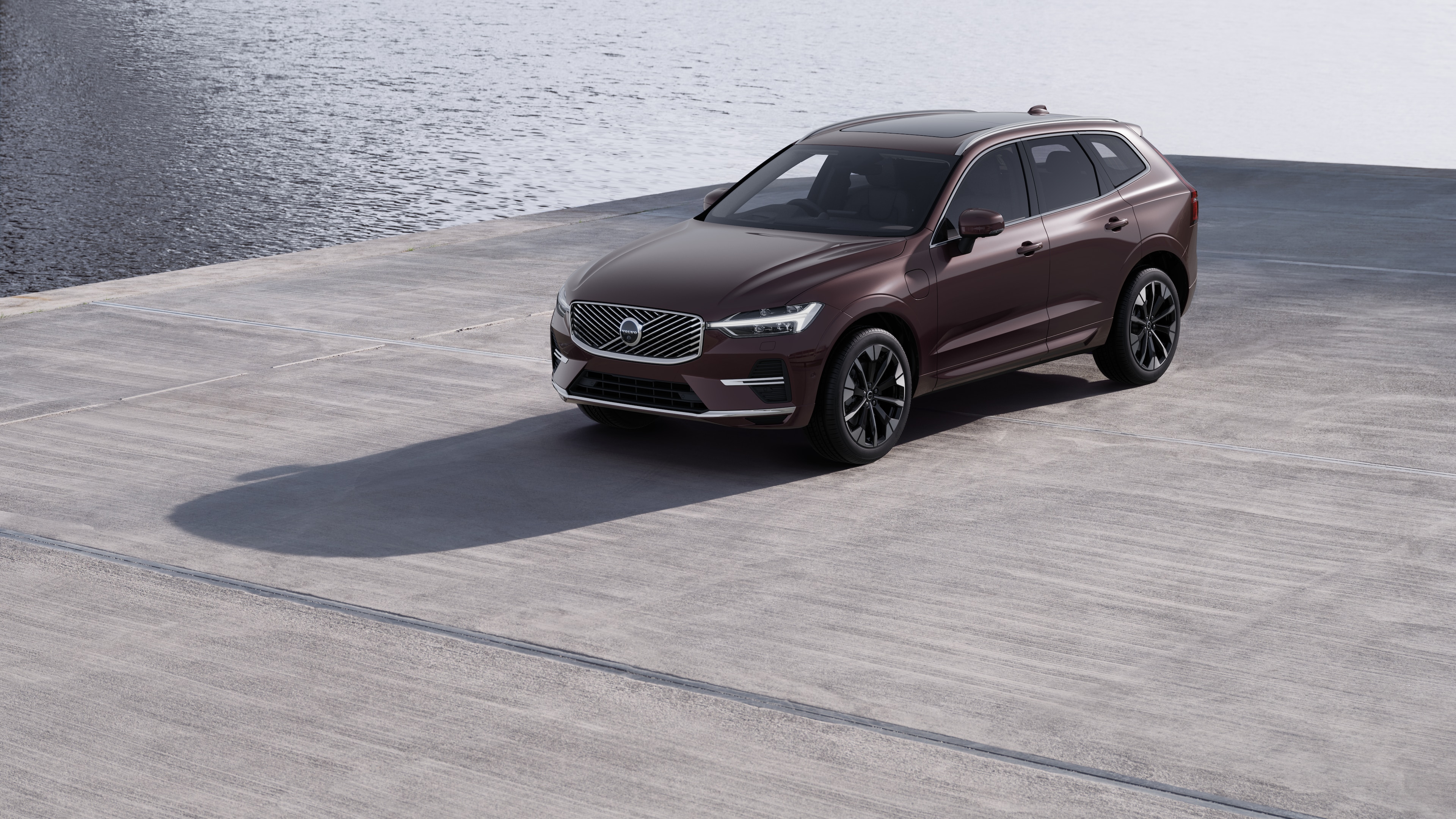 Volvo car exterior in three-quarter view against an industrial concrete wall background.