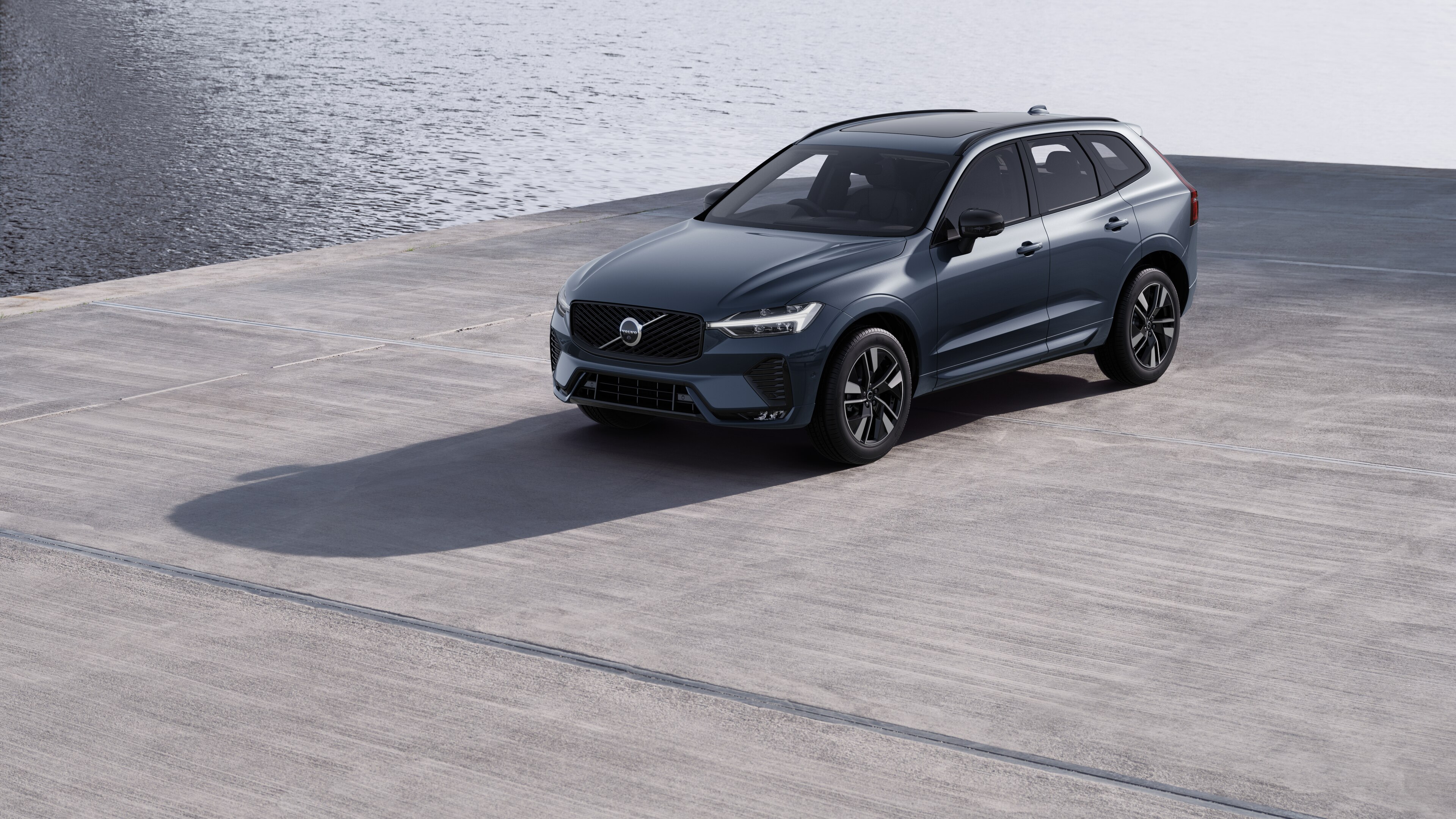 Volvo car exterior in three-quarter view against an industrial concrete wall background.
