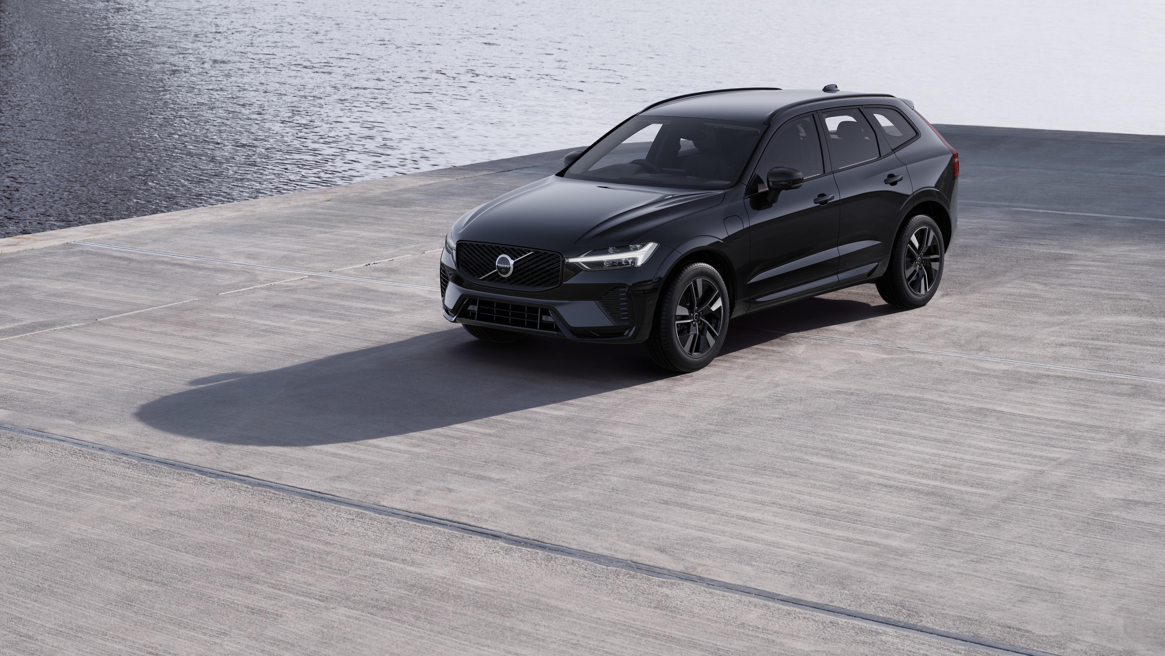 Volvo car exterior in three-quarter view against an industrial concrete wall background.